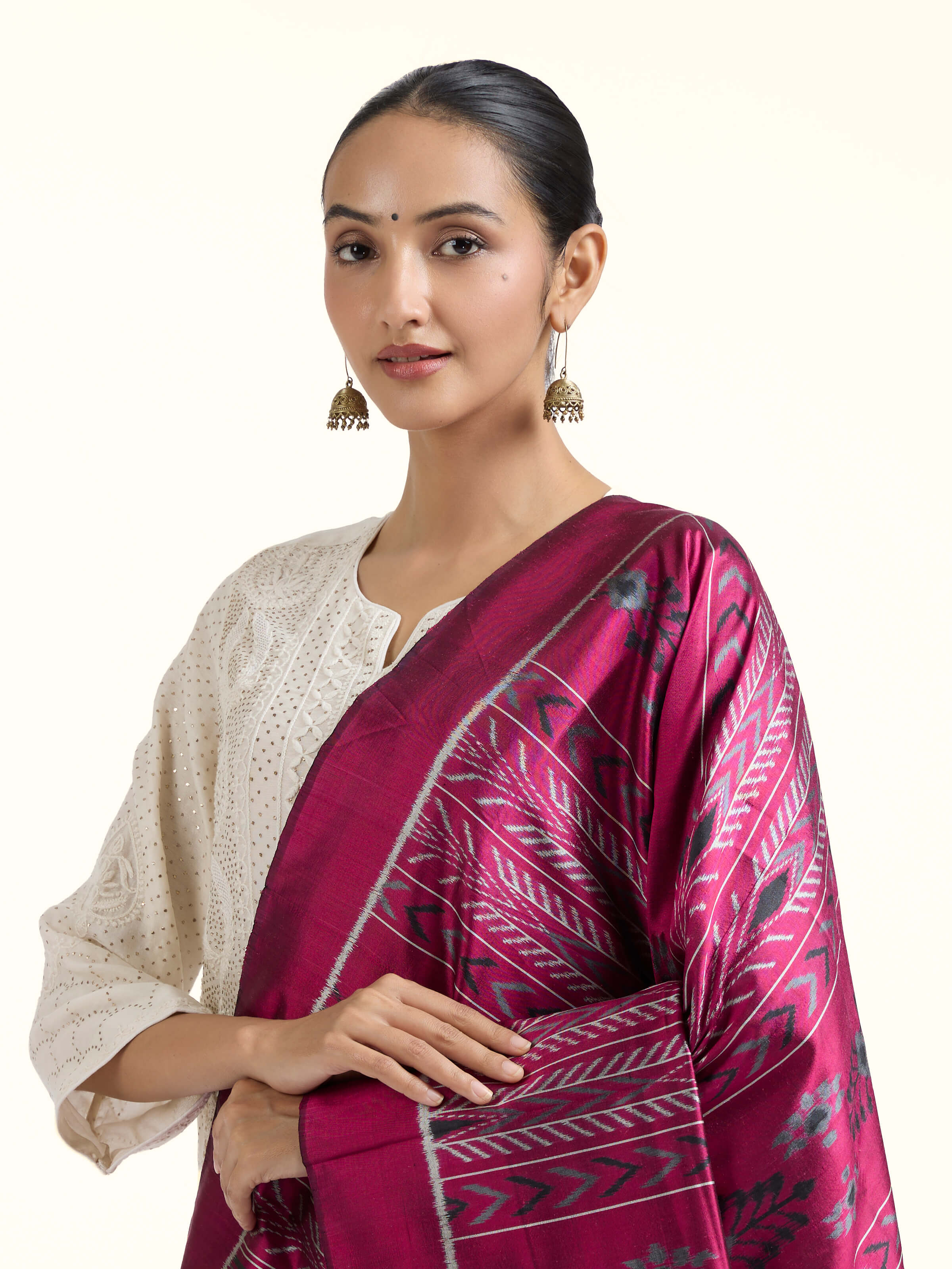 Angled view of pink silk Odisha ikat dupatta highlighting ikat patterns
