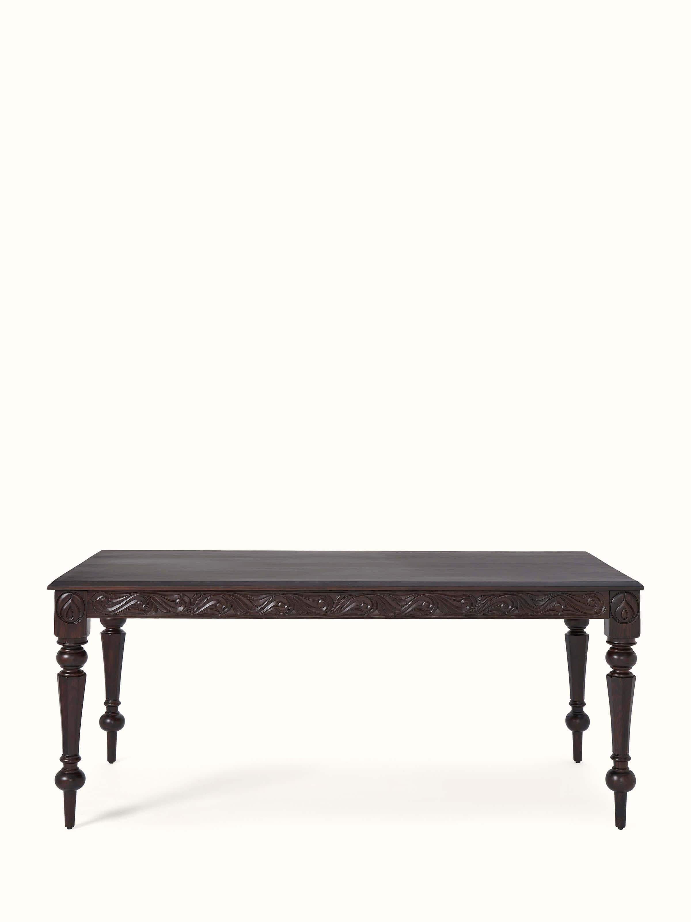 Front view of carved rosewood 6-seater dining table, highlighting its intricate carvings and rich finish