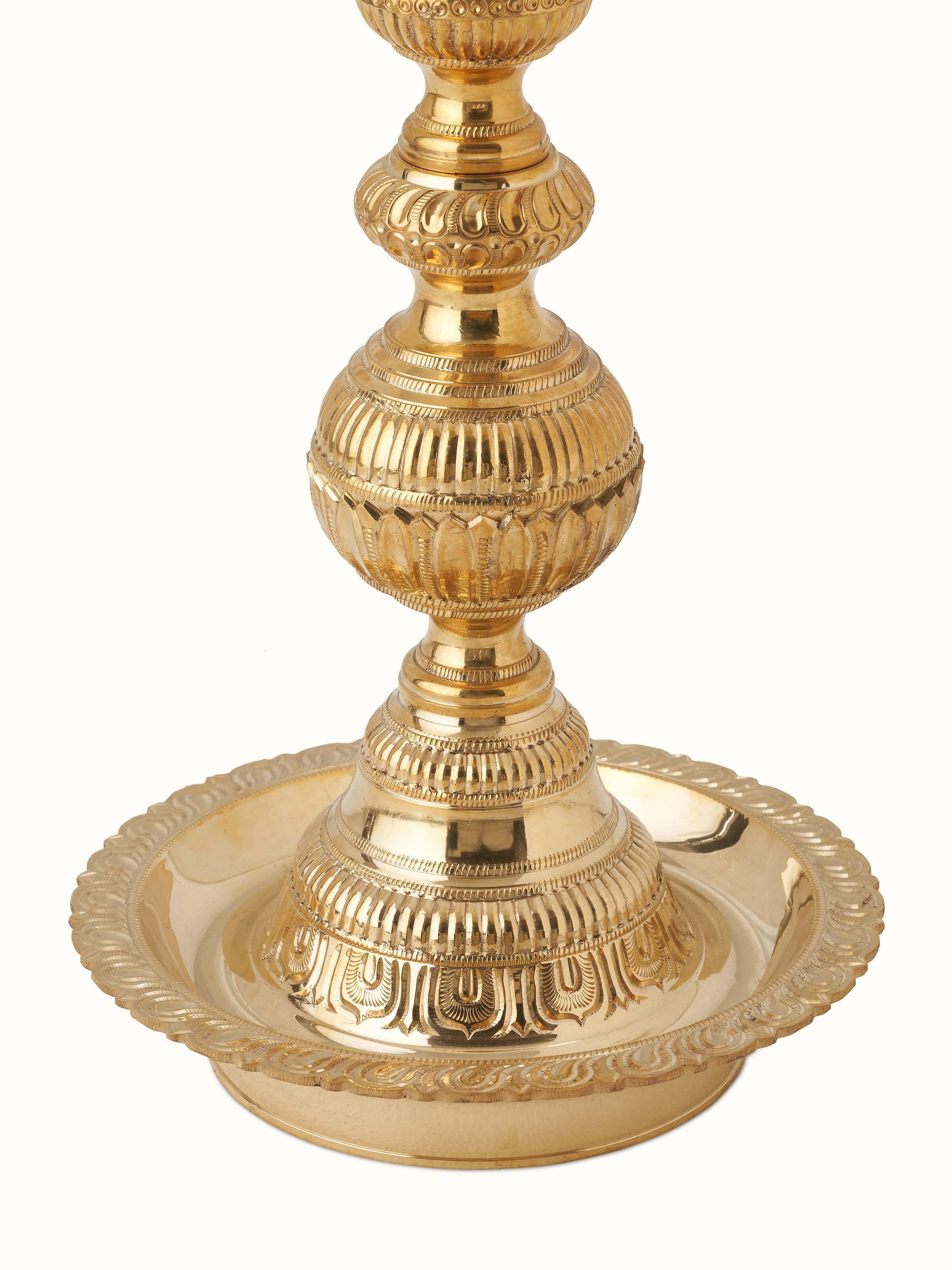 Close-up view of Vilakku Carved Brass Stand Diya highlighting the fine details and brass texture.