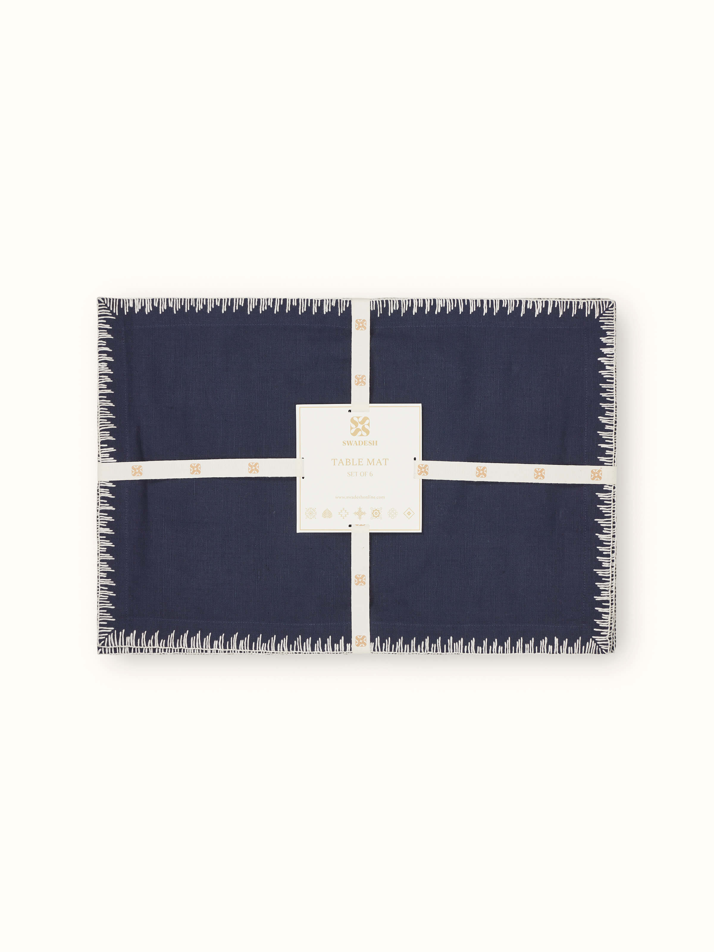 Corner embroidery and stitched border detail on indigo table mat