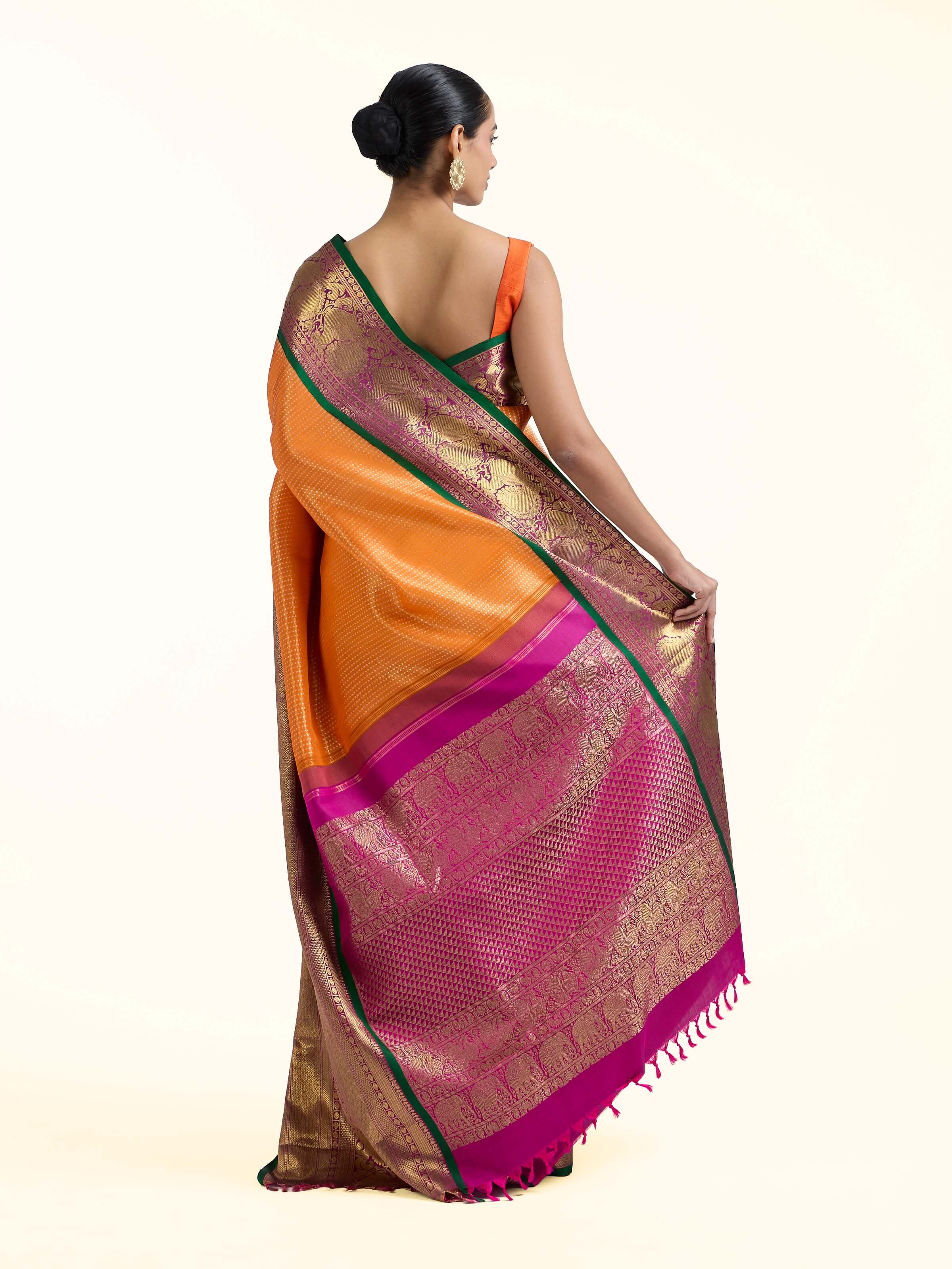 Back view of mango silk Kancheepuram saree displaying detailed pallu