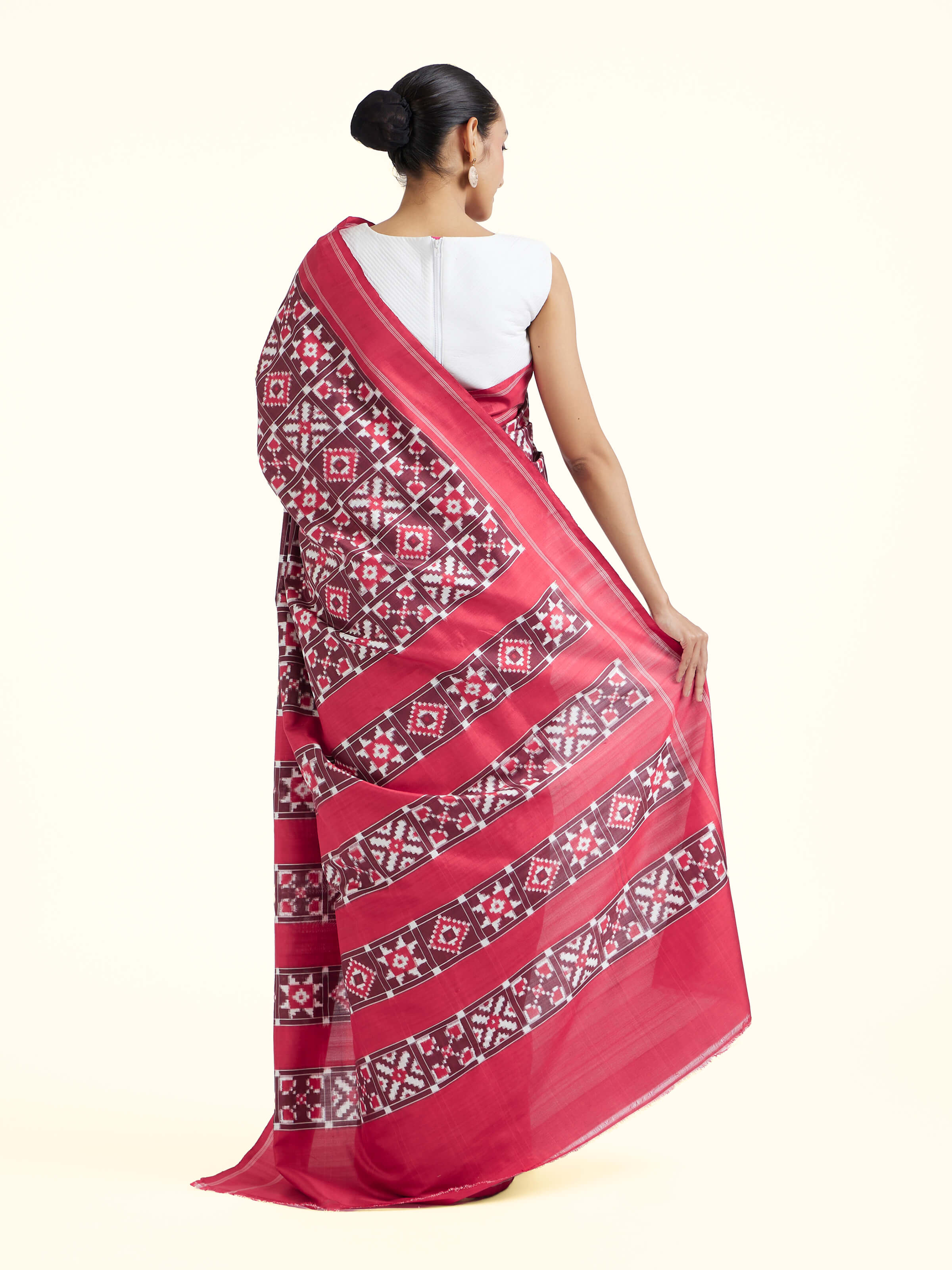 Back view of red mulberry silk Ikat saree displaying pallu and overall weave continuity