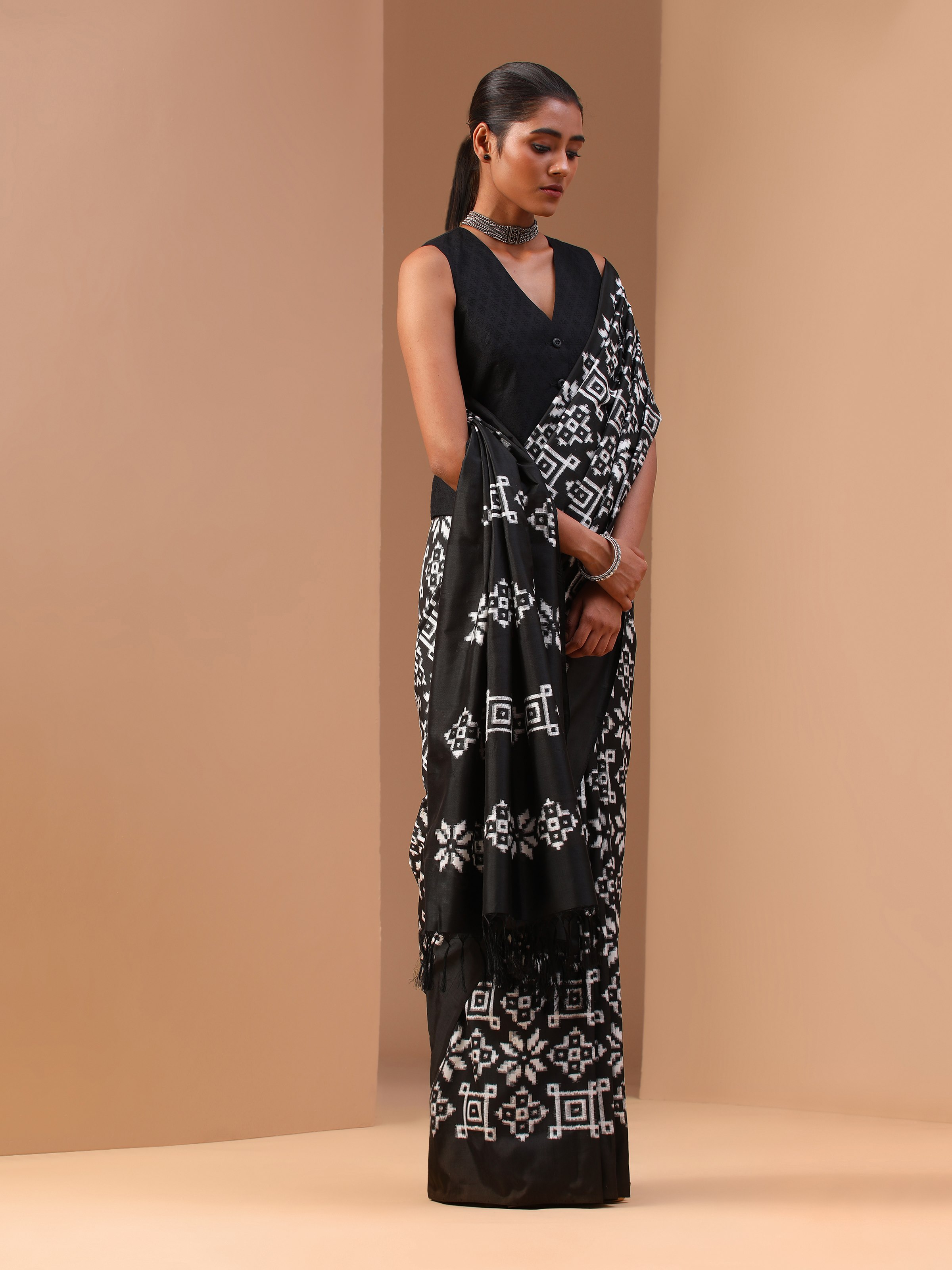 Side profile showing the flowing drape and precise ikat weaving.