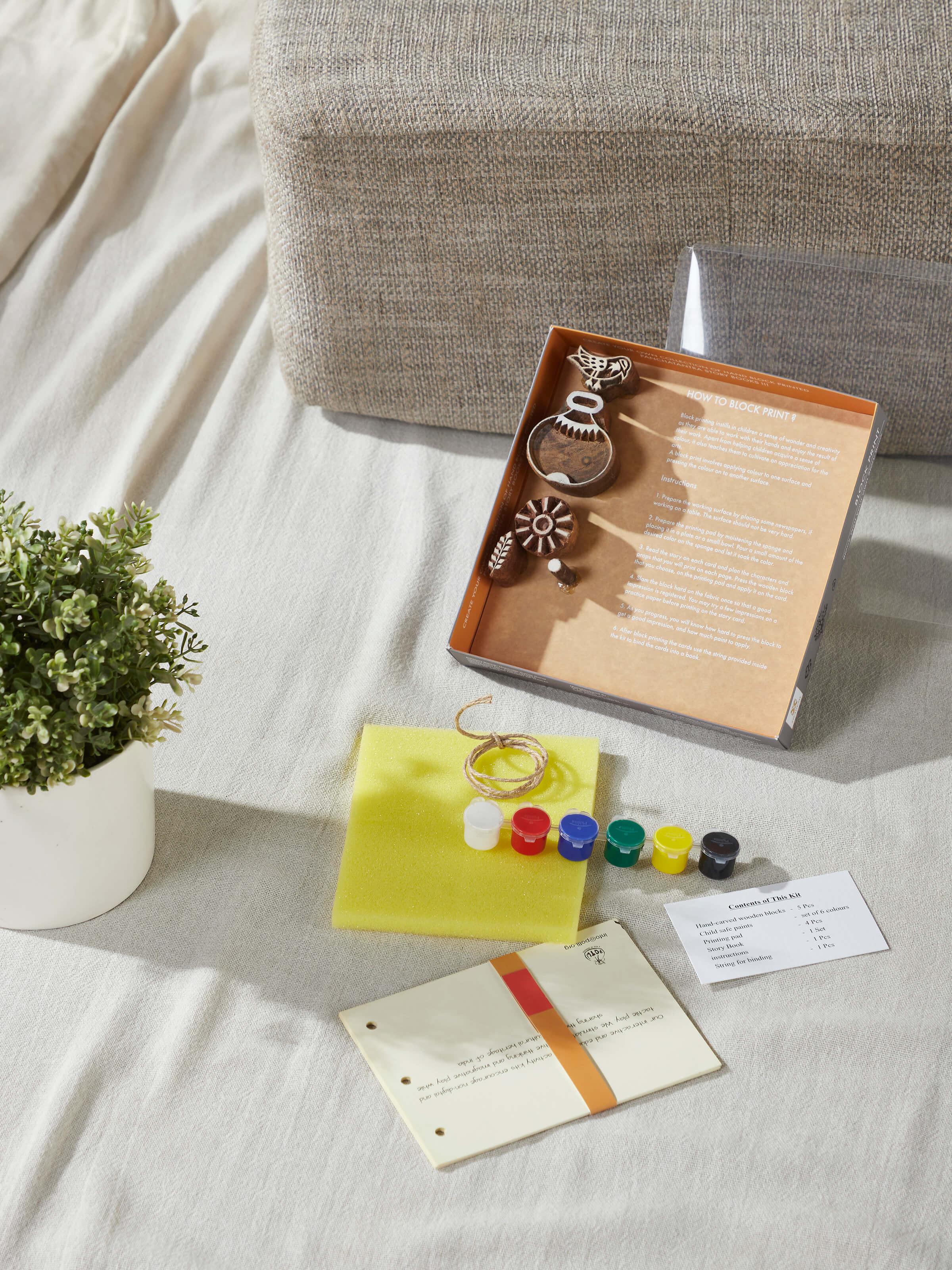 Angled view of Block-making DIY your own story painting kit in green highlighting the various painting tools and vibrant colors