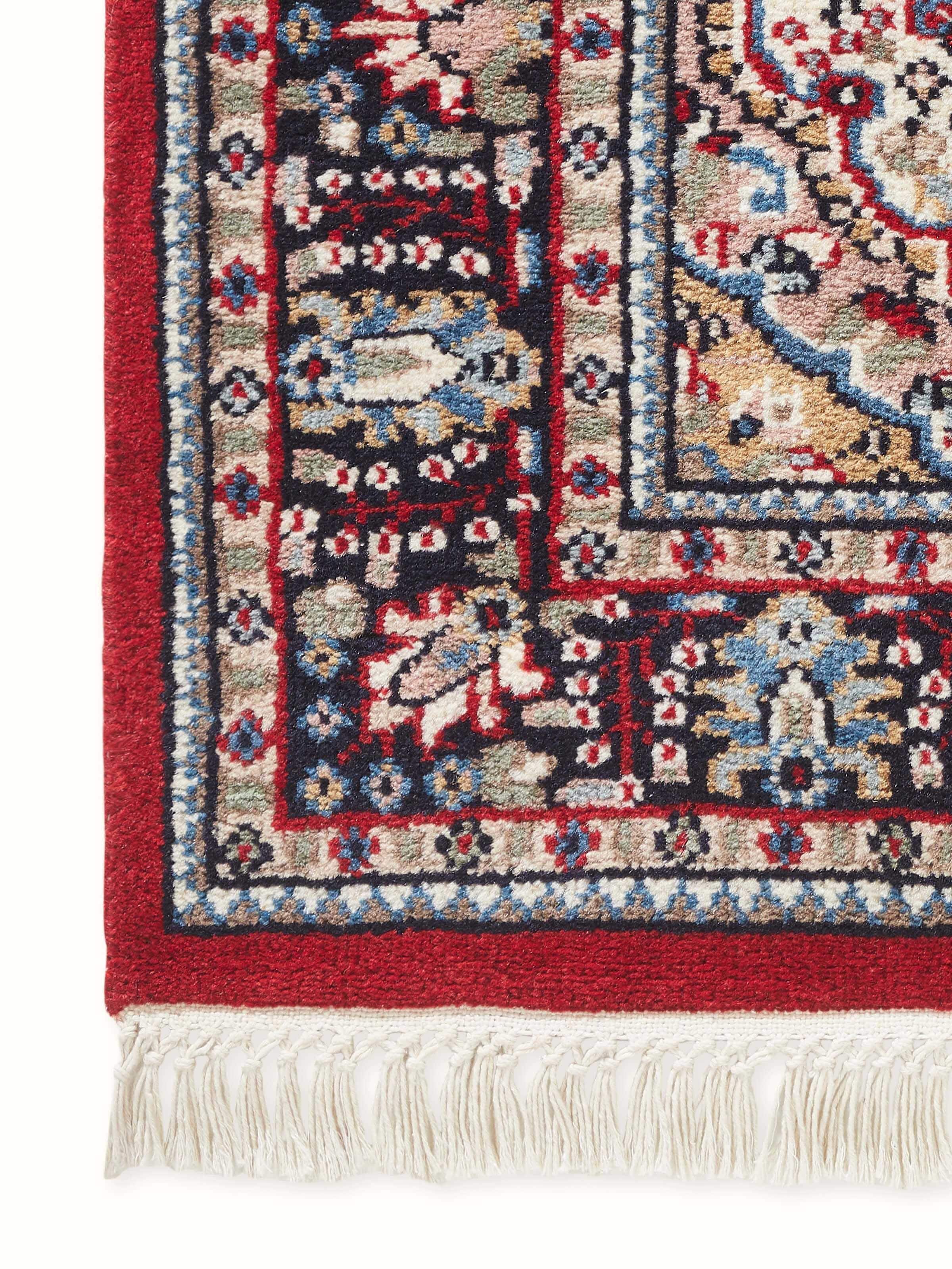 Close-up of Persian red Oriental Gwalior wool carpet showing intricate hand-knotted floral motifs and fine detailing.