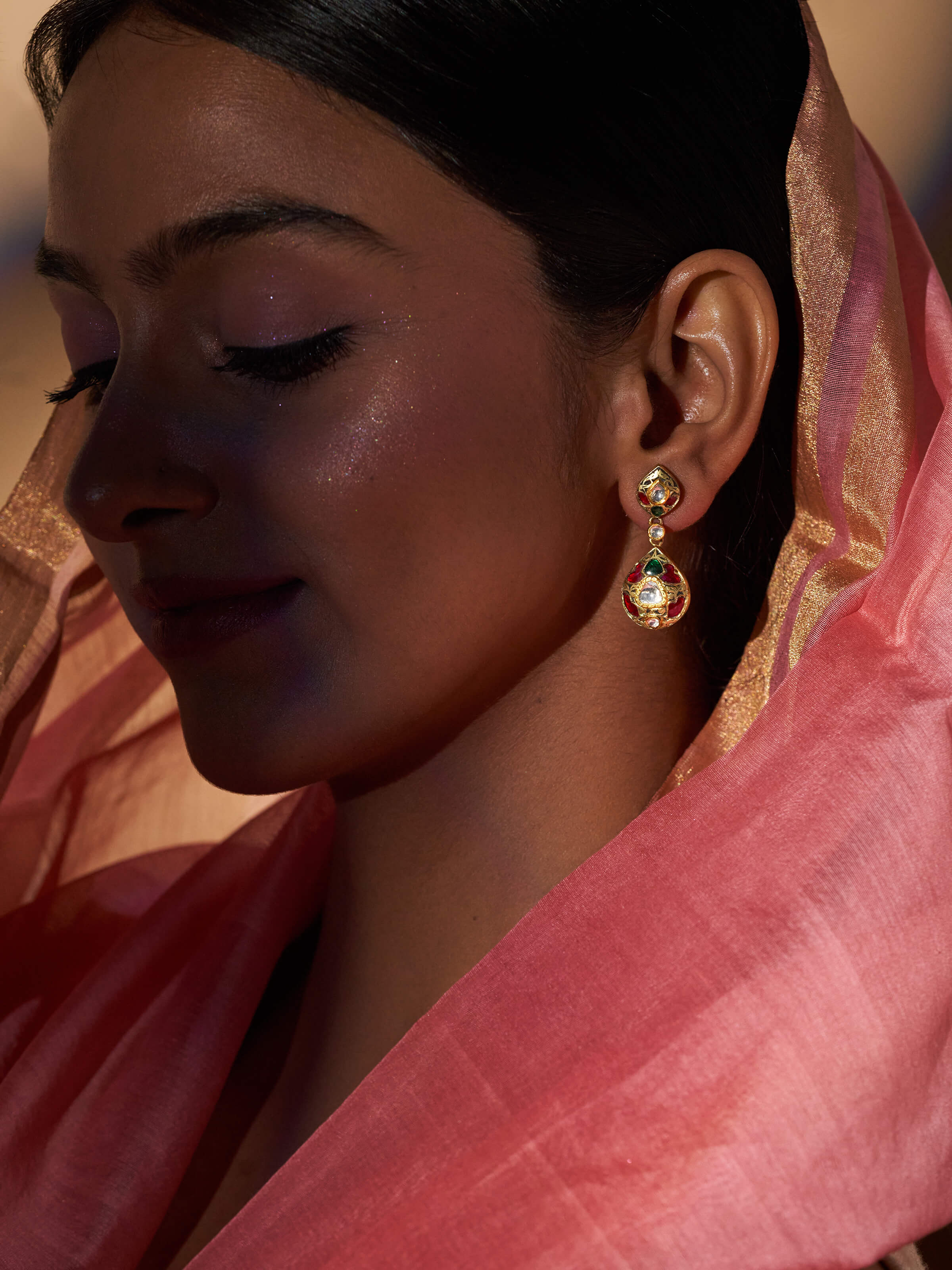 Side view of Partash 18 Karat gold drop earrings highlighting detailed goldwork