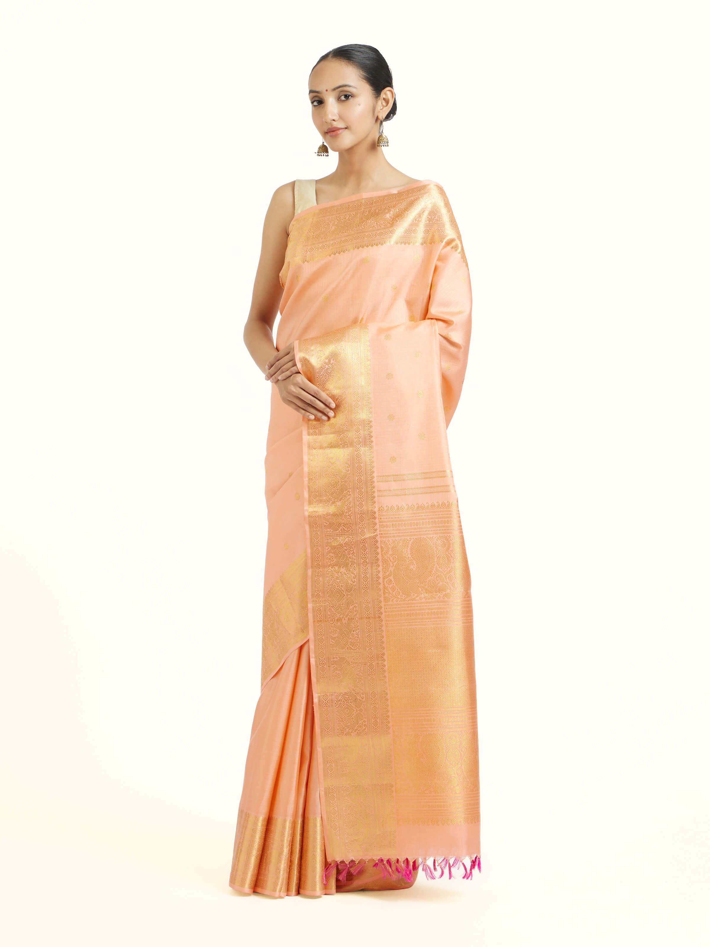 Side view of light pink silk Kancheepuram saree showcasing elegant drape