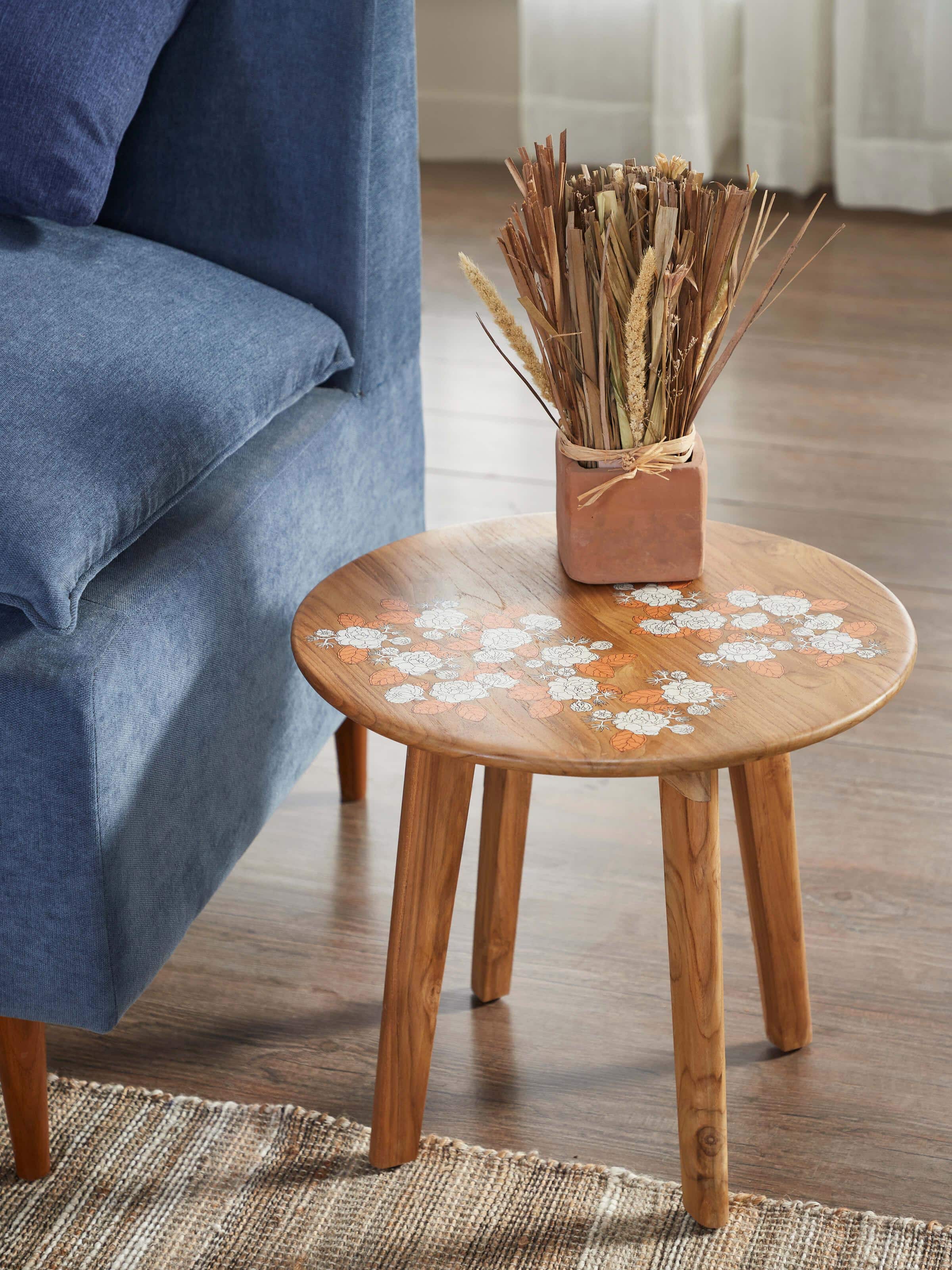 Side view of Teak Wood Pattachitra Round Side Table highlighting the carved details