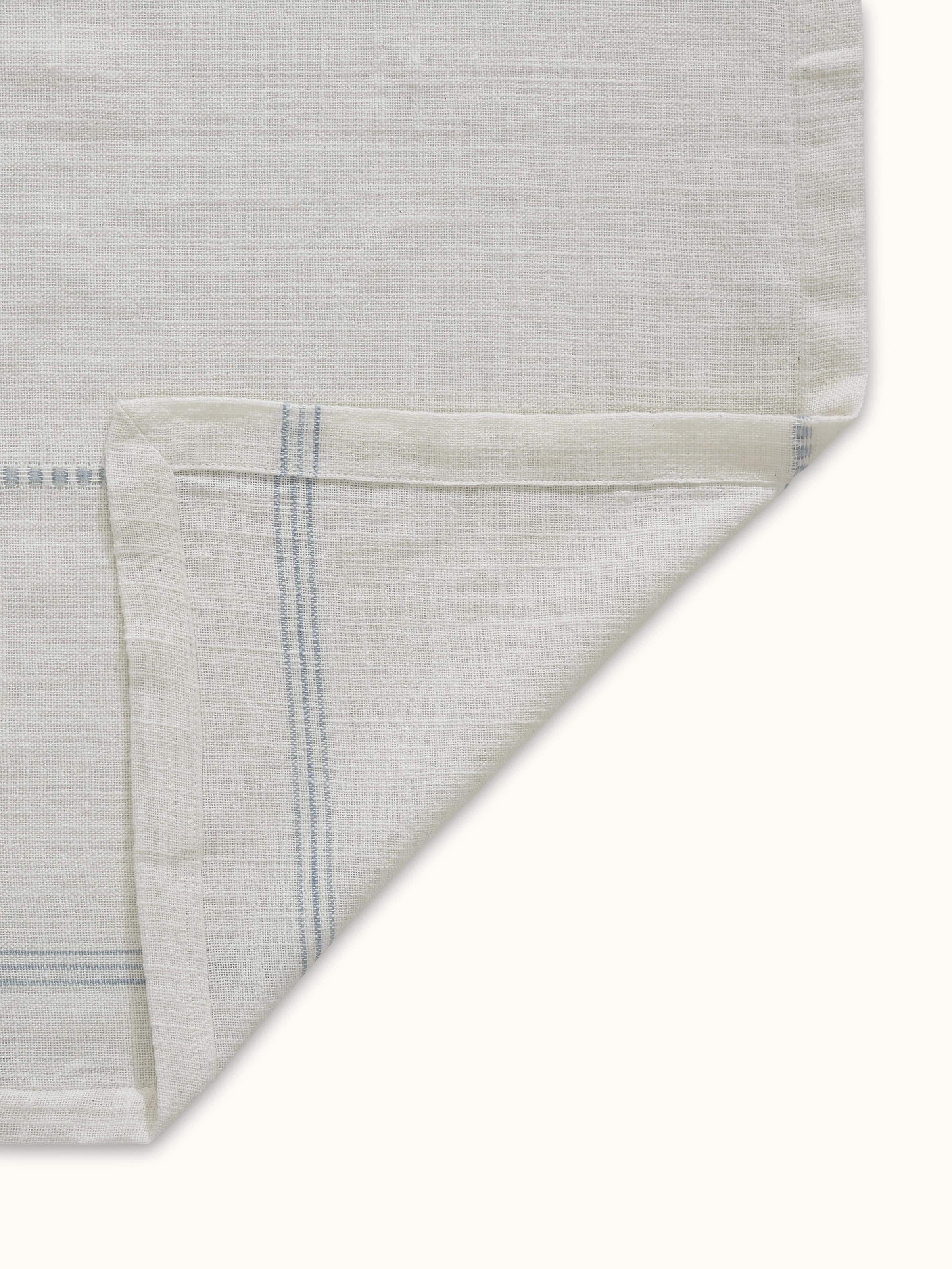 Back view of Arth light blue stripe cotton handloom table cover showing reverse fabric side and finished corners.
