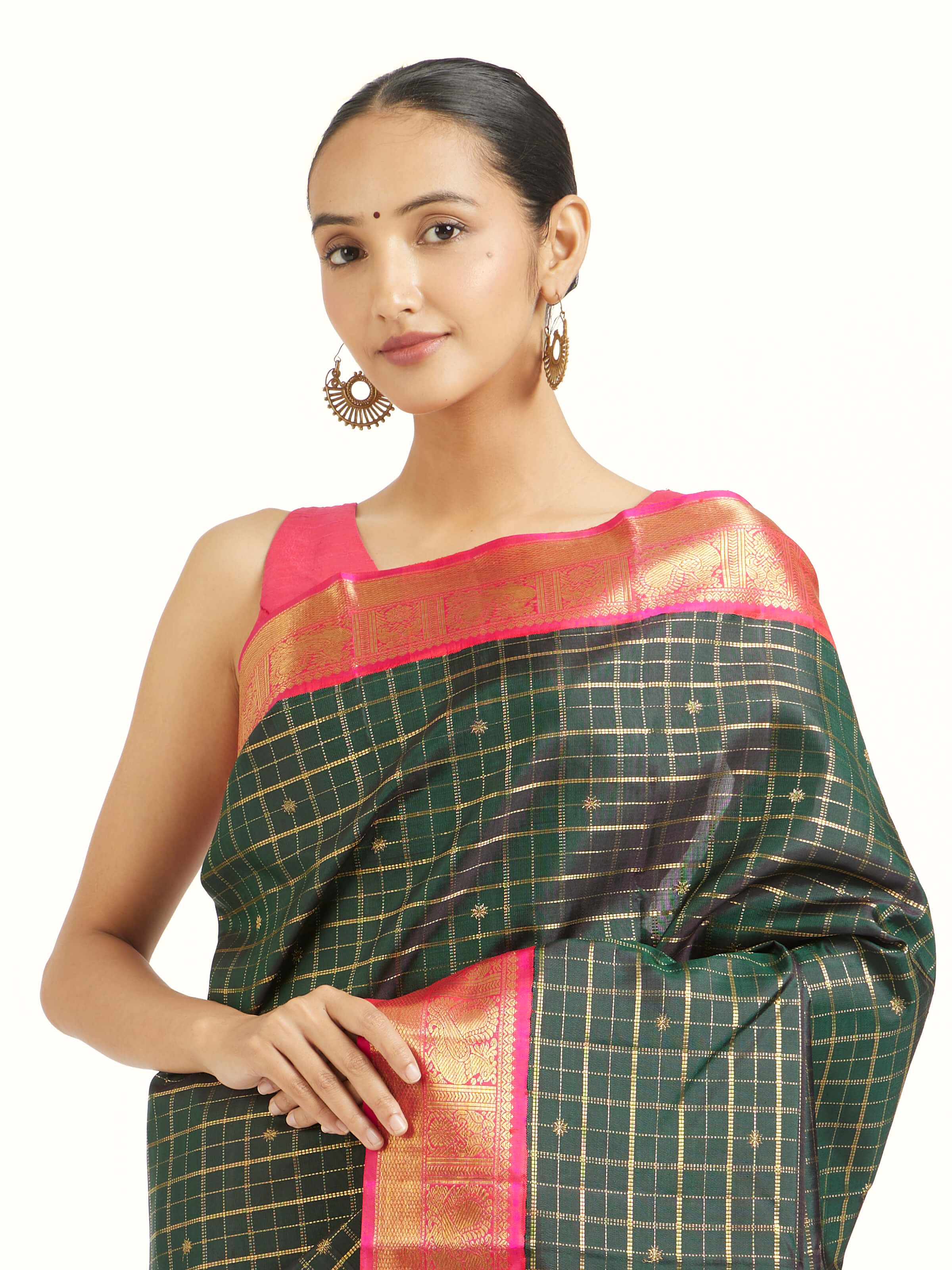 Angled view of green silk Kancheepuram saree highlighting traditional weave and natural sheen