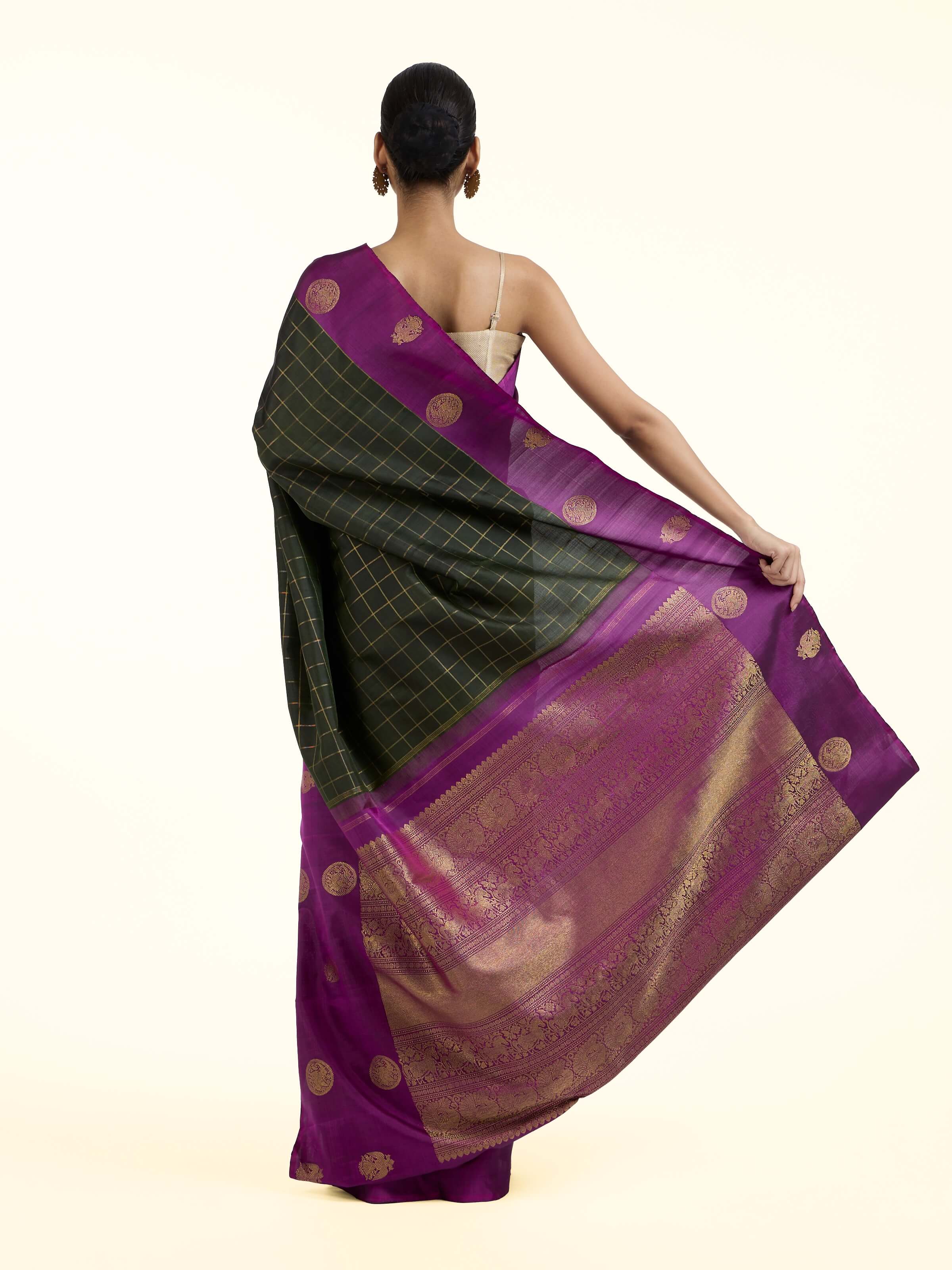 Back view of black silk Kancheepuram saree displaying ornate pallu design