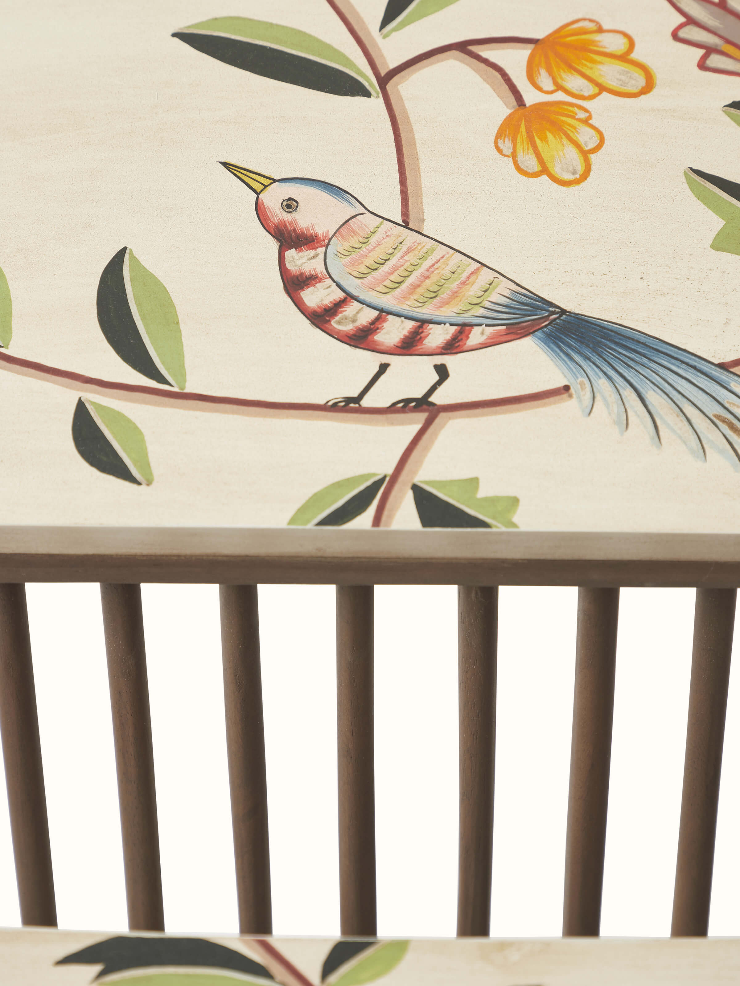 Close-up view of the side of the mango wood magazine rack with miniature painting, emphasizing the detailed artwork.