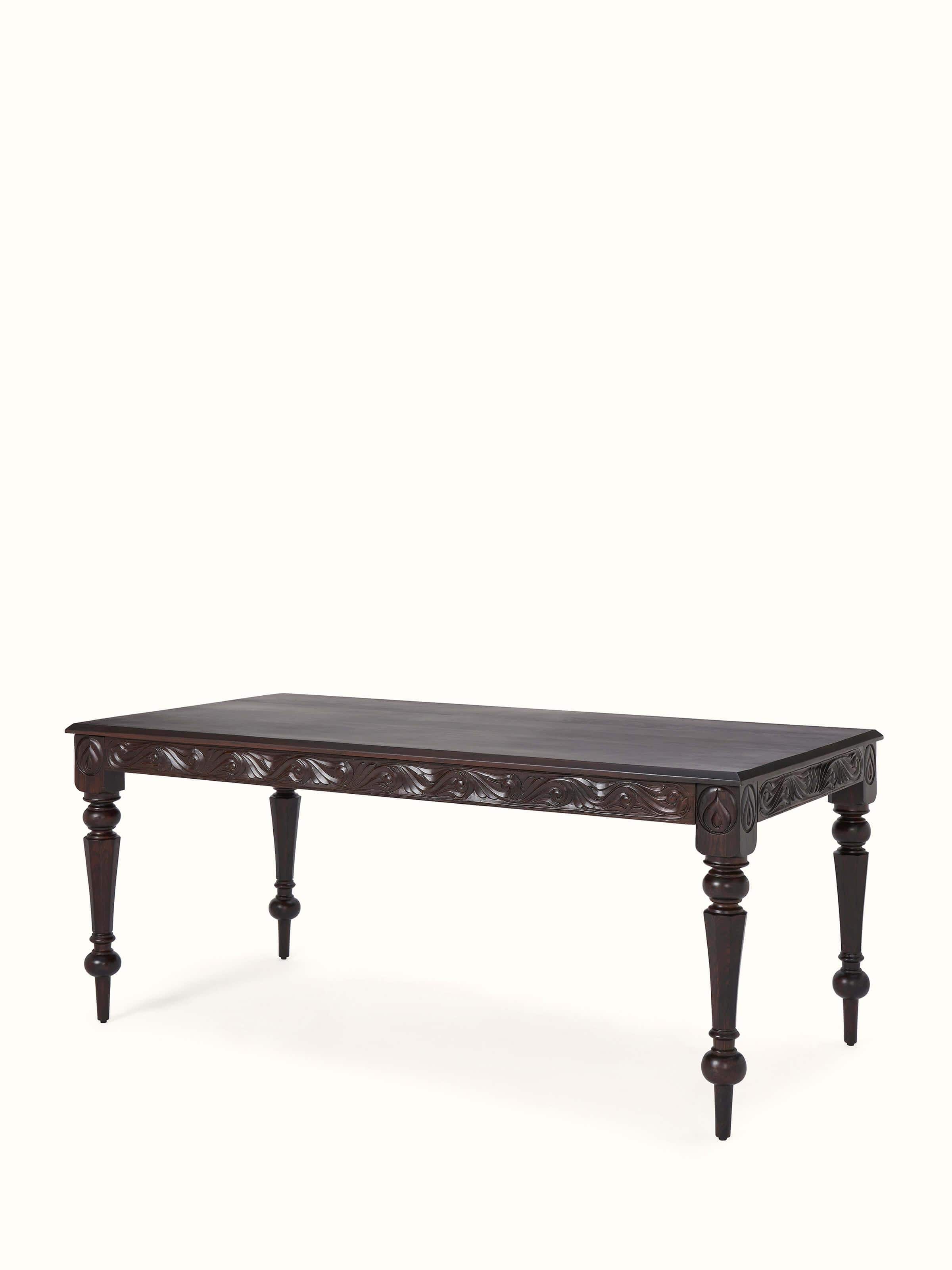 Side view of carved rosewood 6-seater dining table, showing detailed woodwork and elegant design