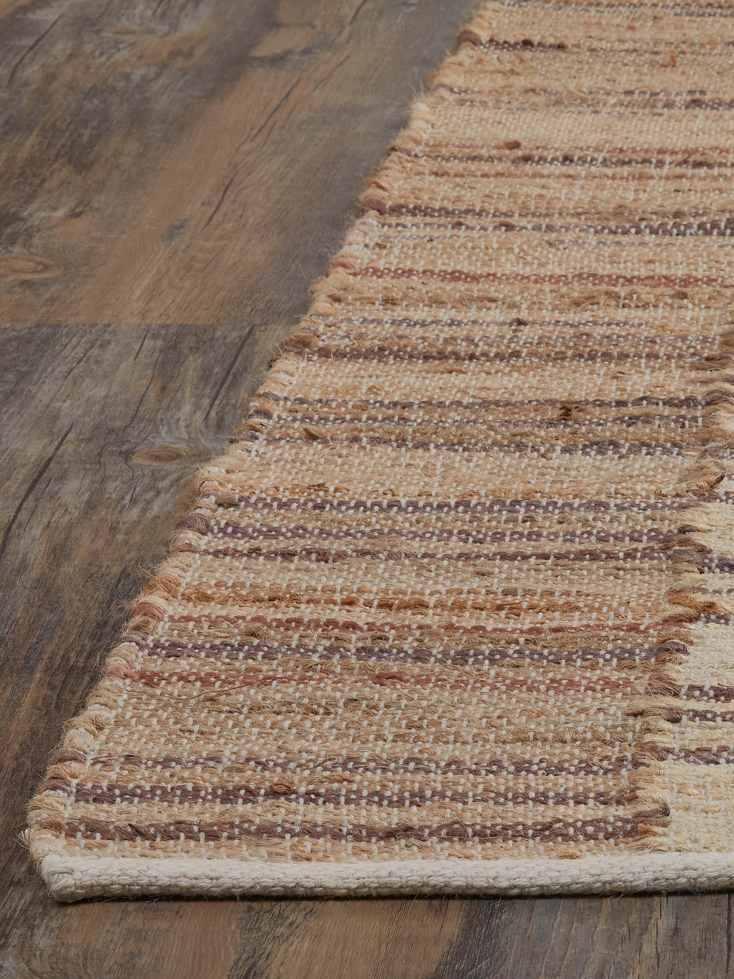 Angled view of Lawan Beige Brown Jute Rug highlighting the striped pattern and natural texture