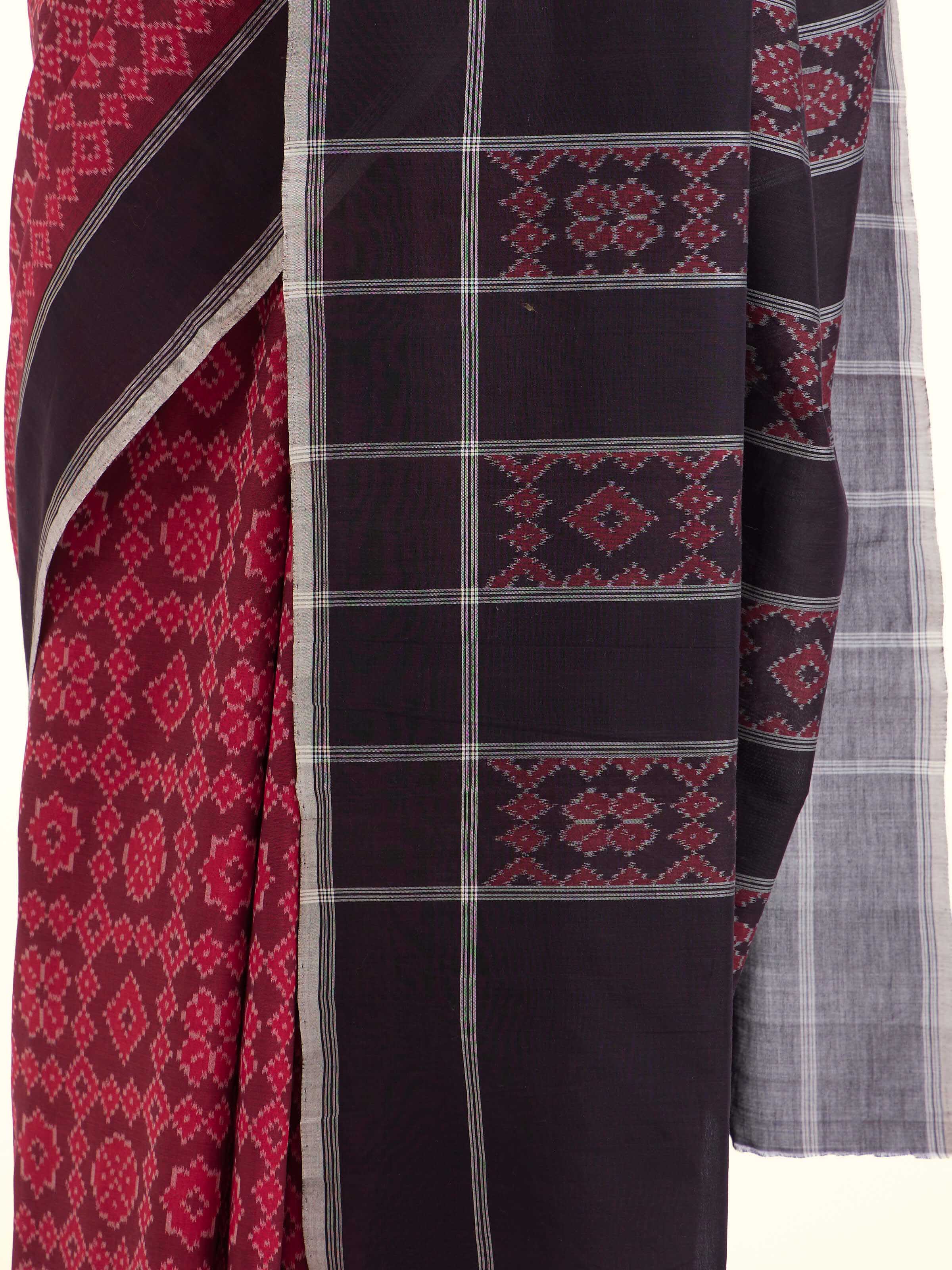 Detail view of maroon mulberry silk ikat saree showing silk texture and craftsmanship