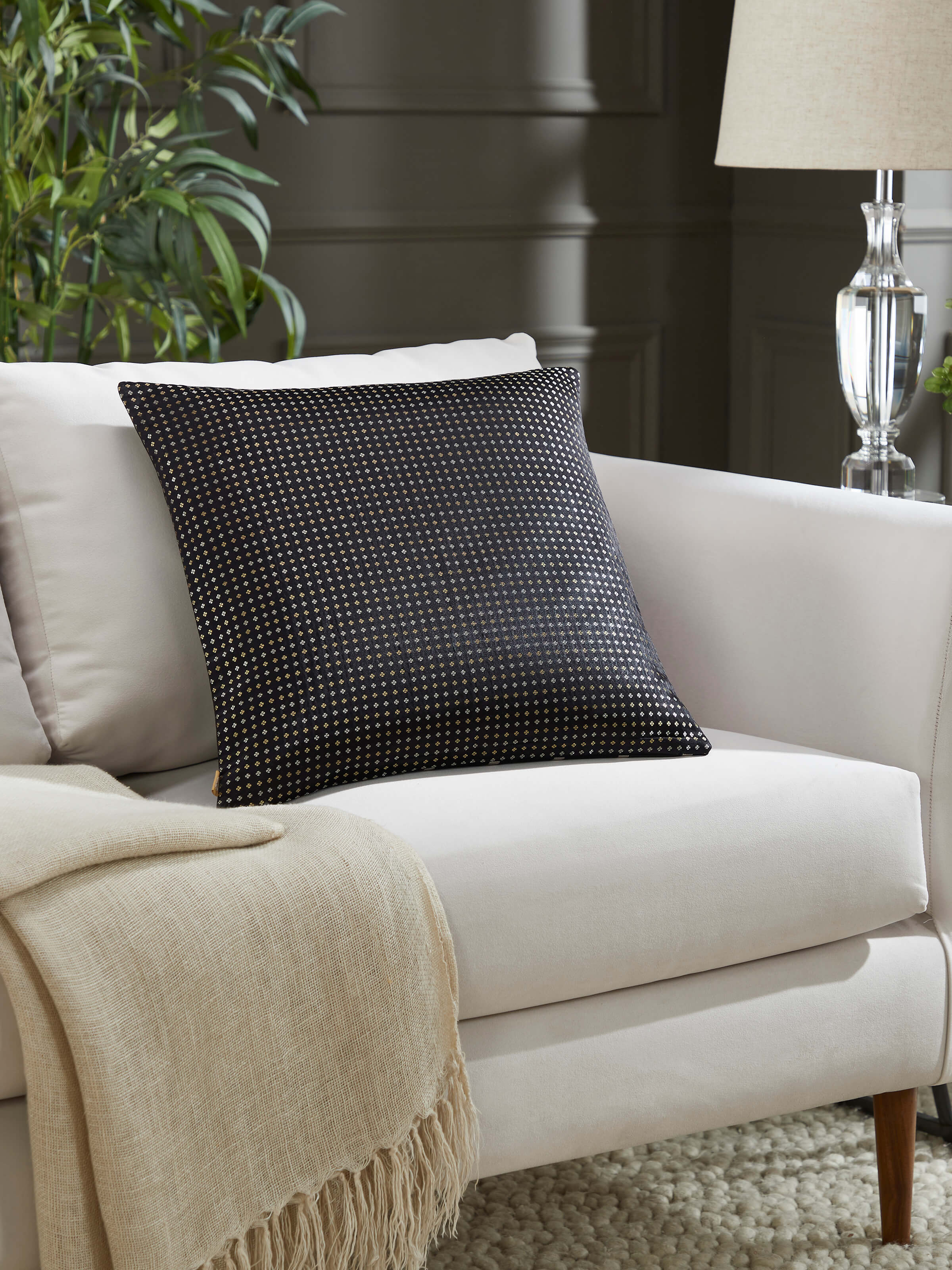 Awadh black striped Banarasi cushion cover styled in a living space for an elegant traditional look