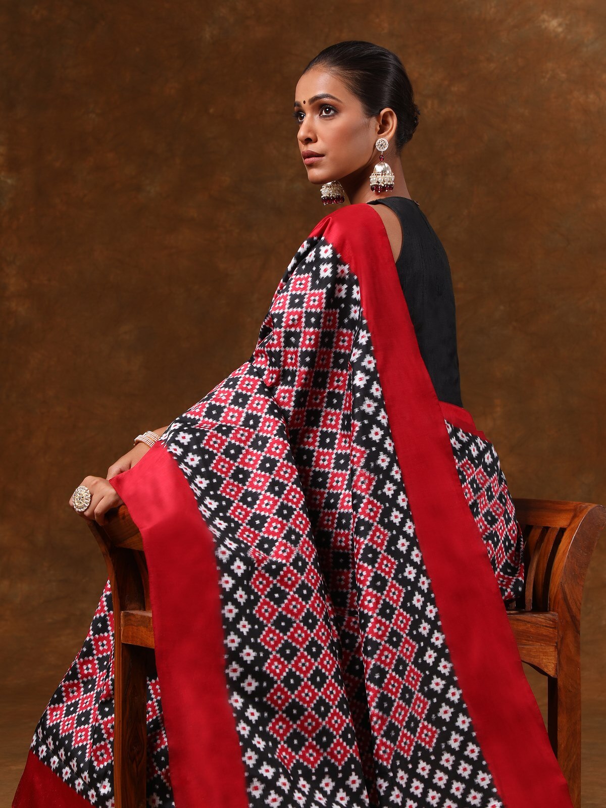 Detail shot of black silk Telia Rumal saree showing fine Ikat weave