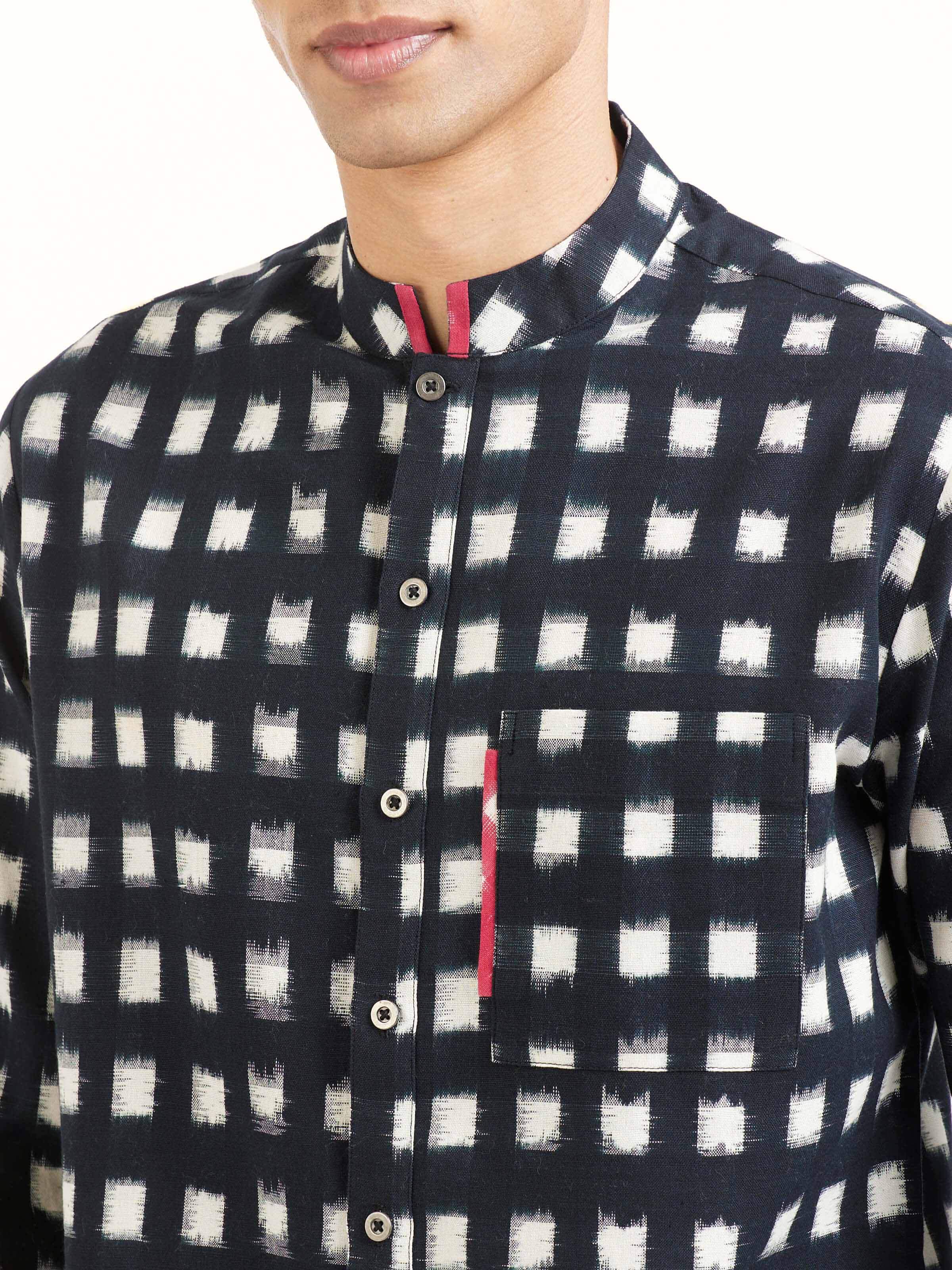 Detail view of black cotton Telangana Ikat shirt showing fabric texture and pattern clarity