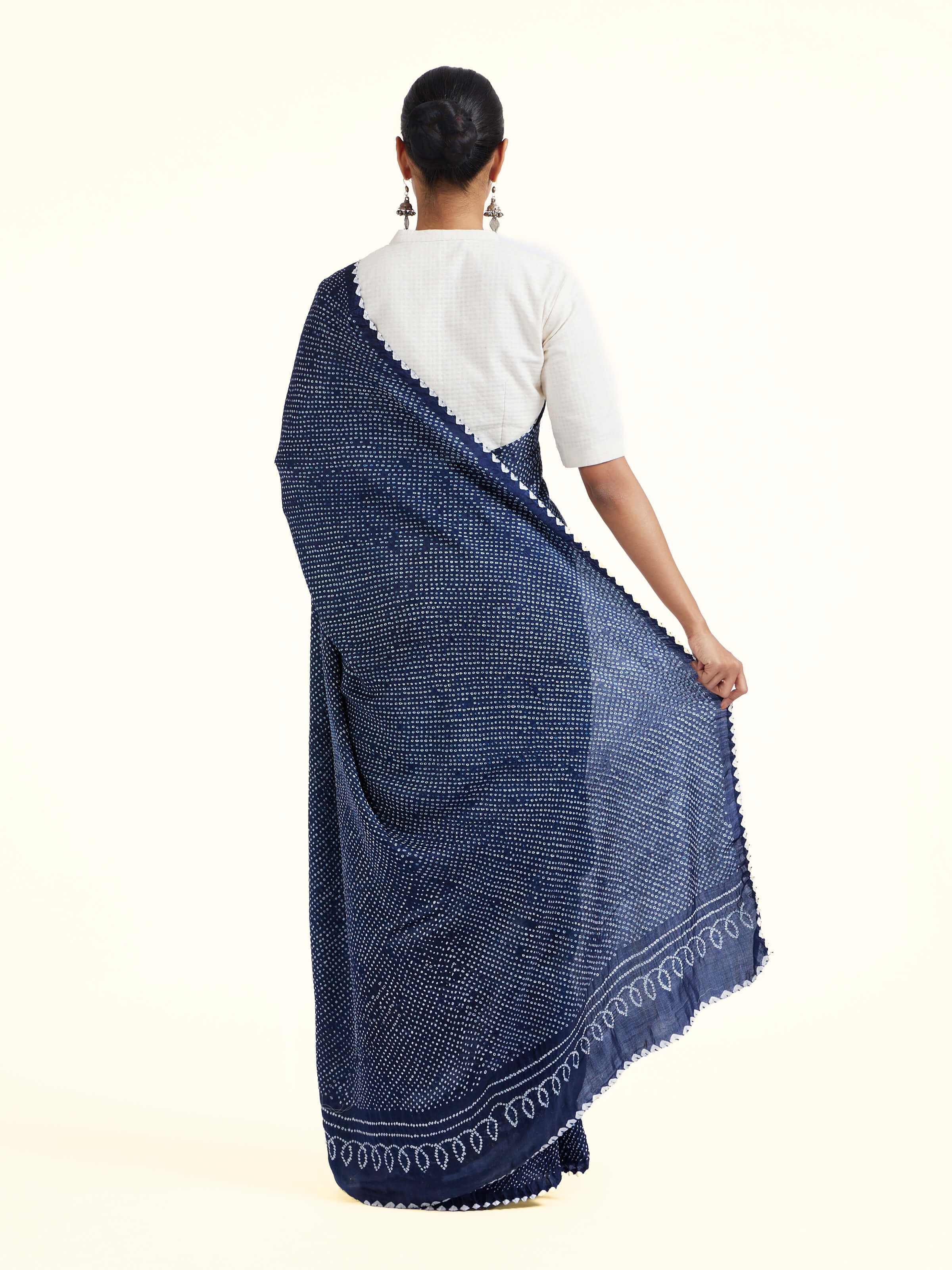 Back view of black silk tie and dye bandhani saree displaying pallu design