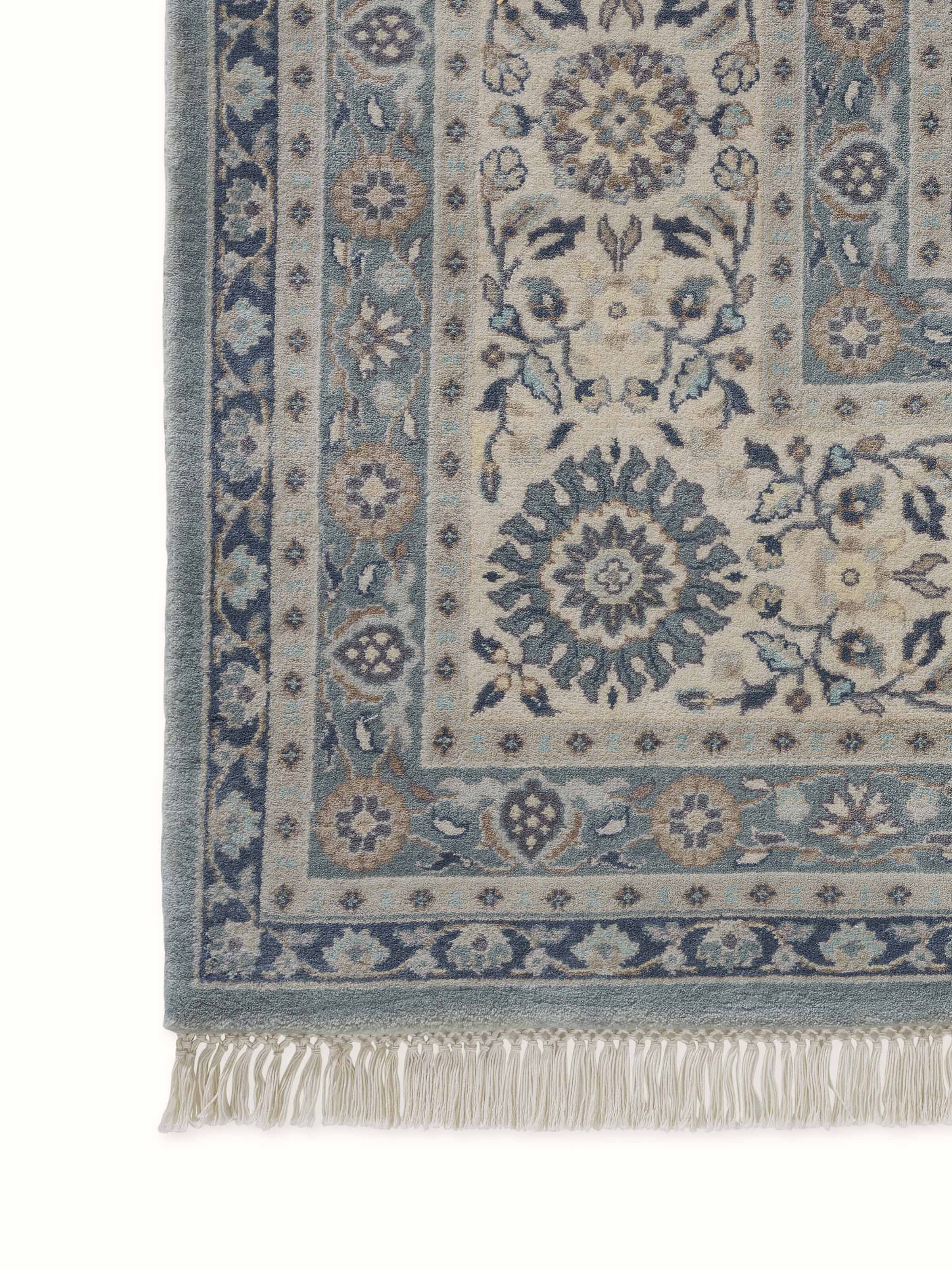 Design close-up capturing the pattern work of traditional blue-grey Sarouk rug