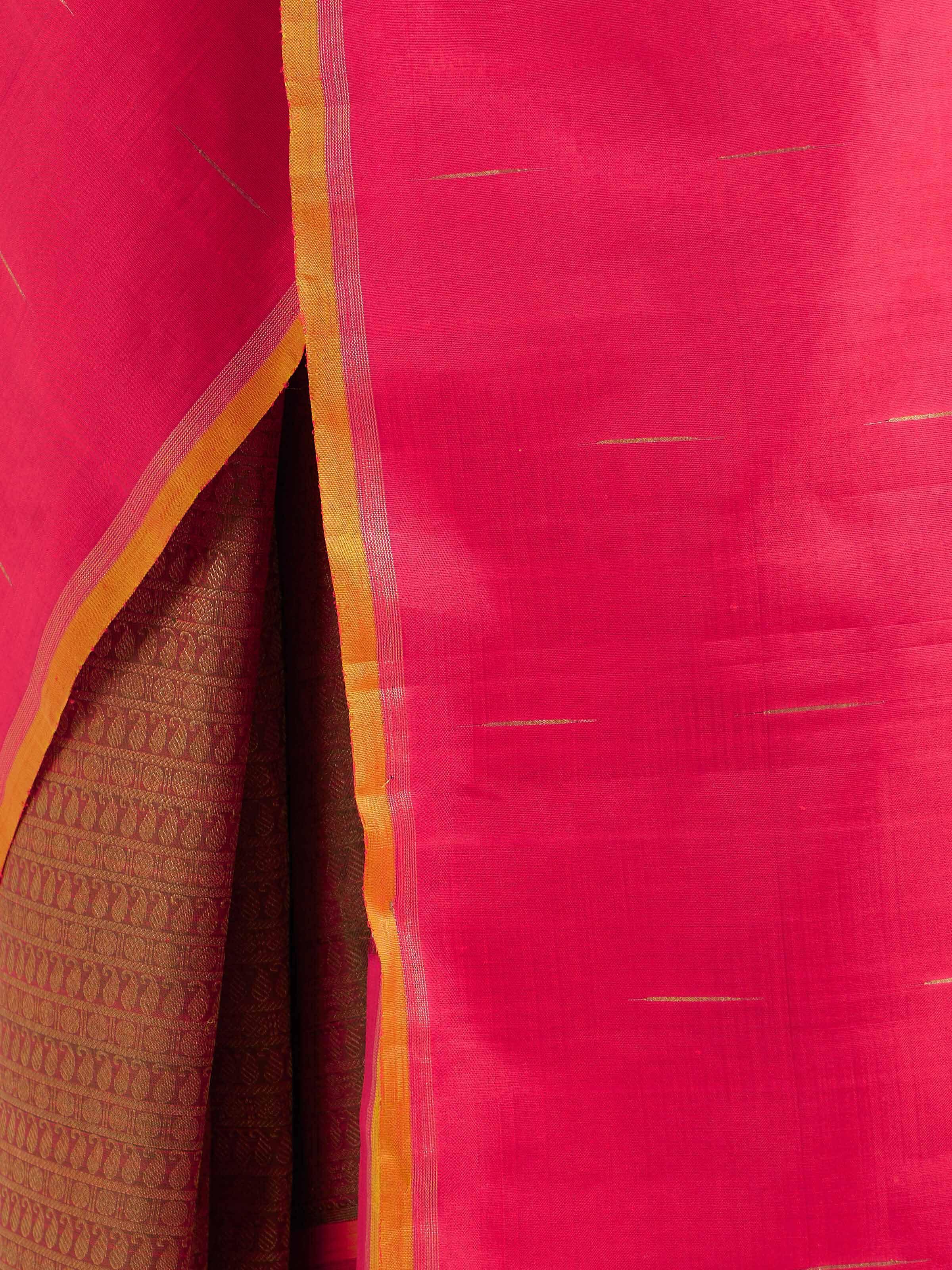 Detail view of red silk Kancheepuram saree showing zari work