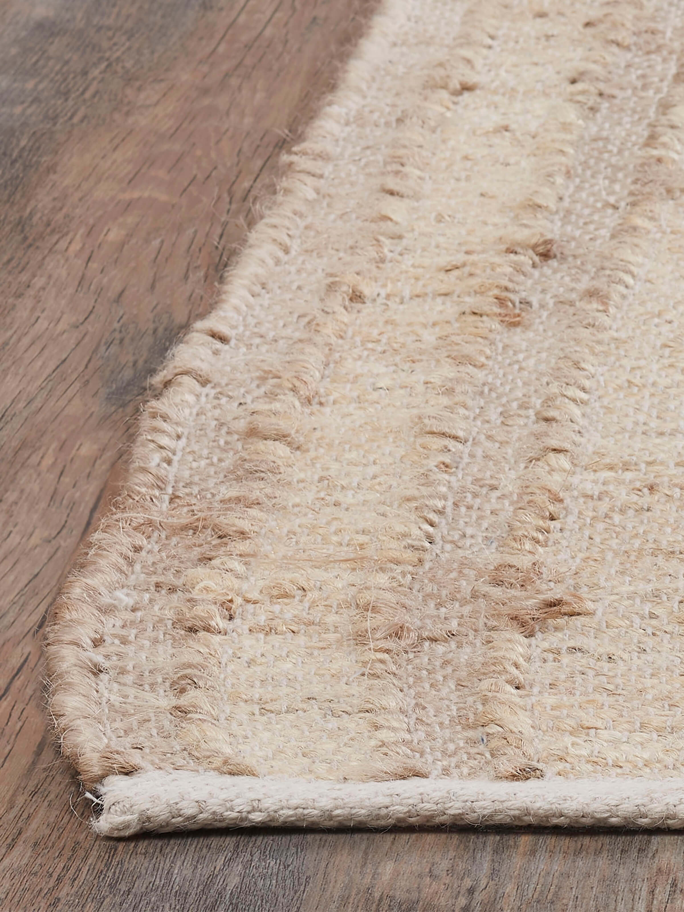 Detailed view of Contemporary geo beige jute & cotton natural fibre rug (5x8 ft) highlighting the natural fiber texture and design.