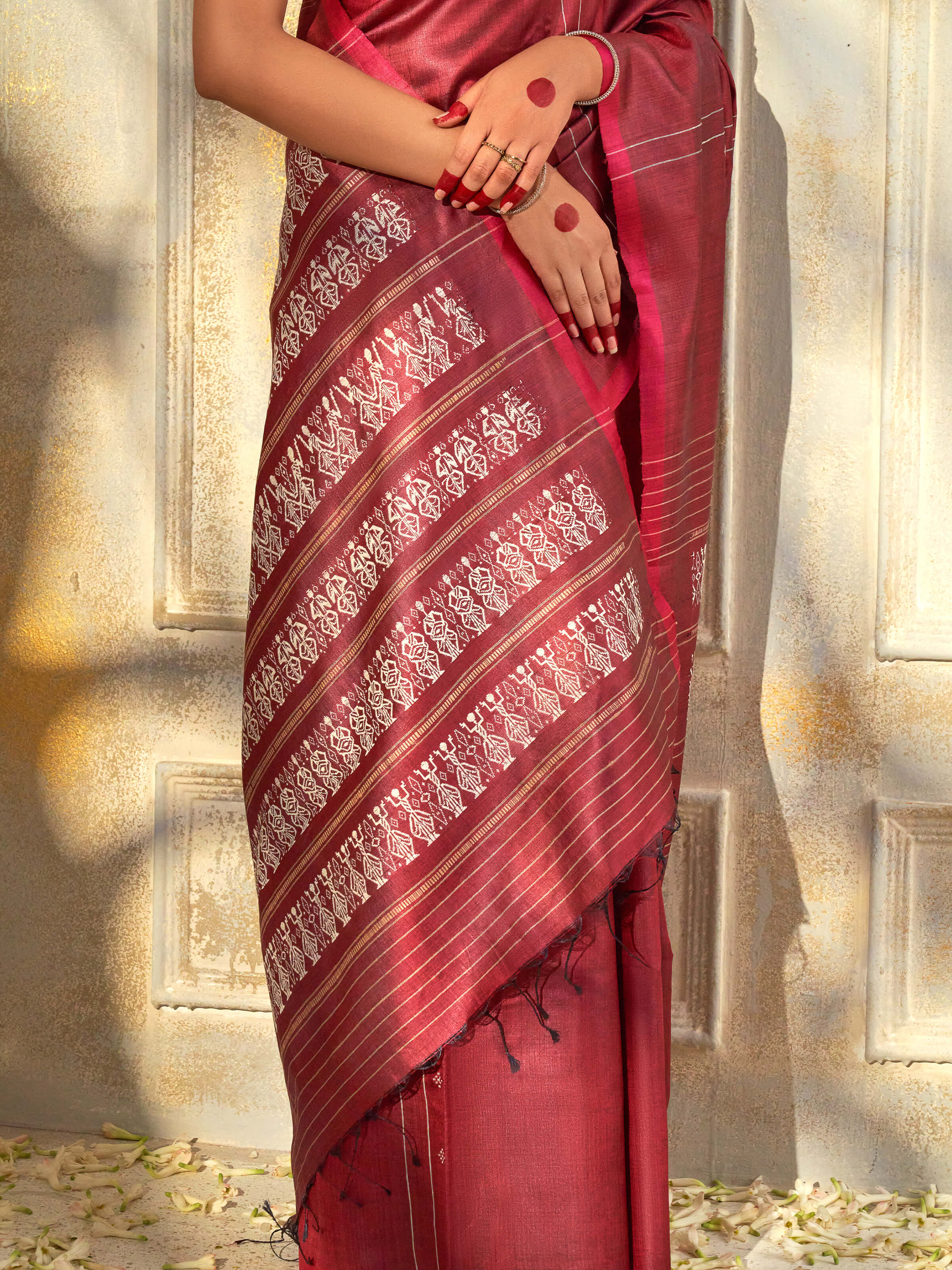 Detail view of maroon tussar silk Odisha ikat saree showing tussar texture and craftsmanship