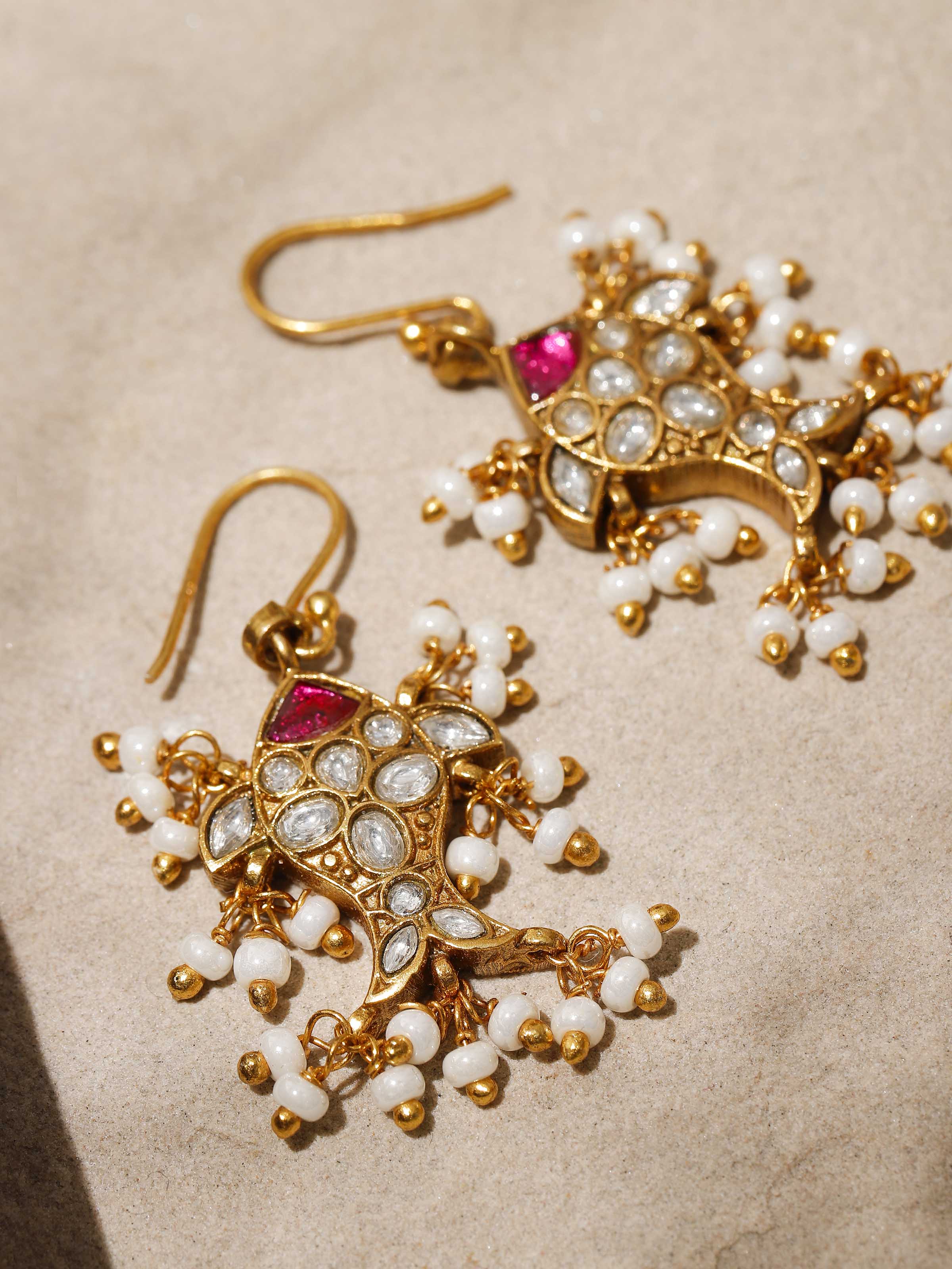 Overhead shot showing the earrings’ length and delicate drop shape