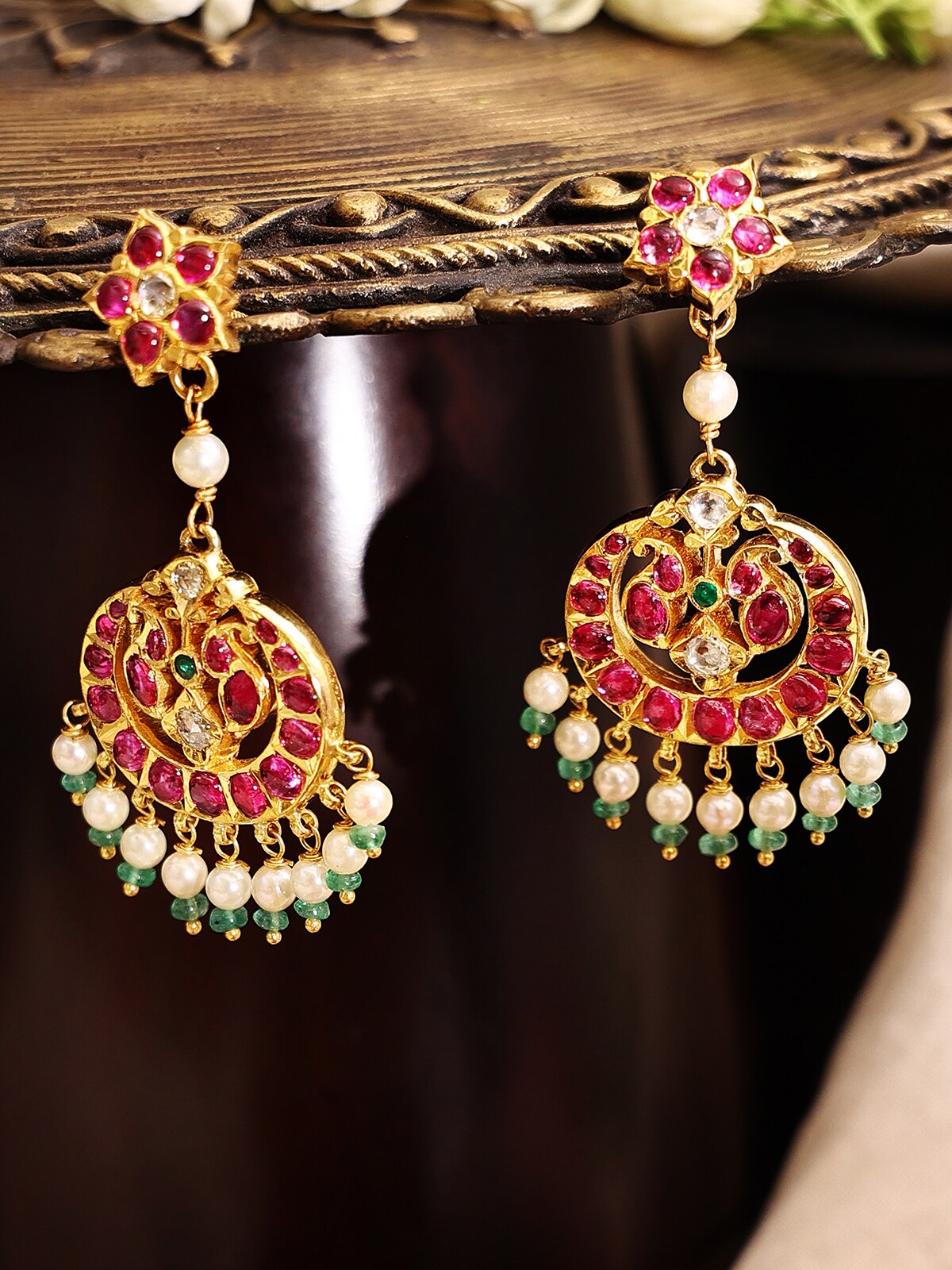 Close-up view of Kundala Velai 22 karat gold drop earrings emphasizing their fine goldwork