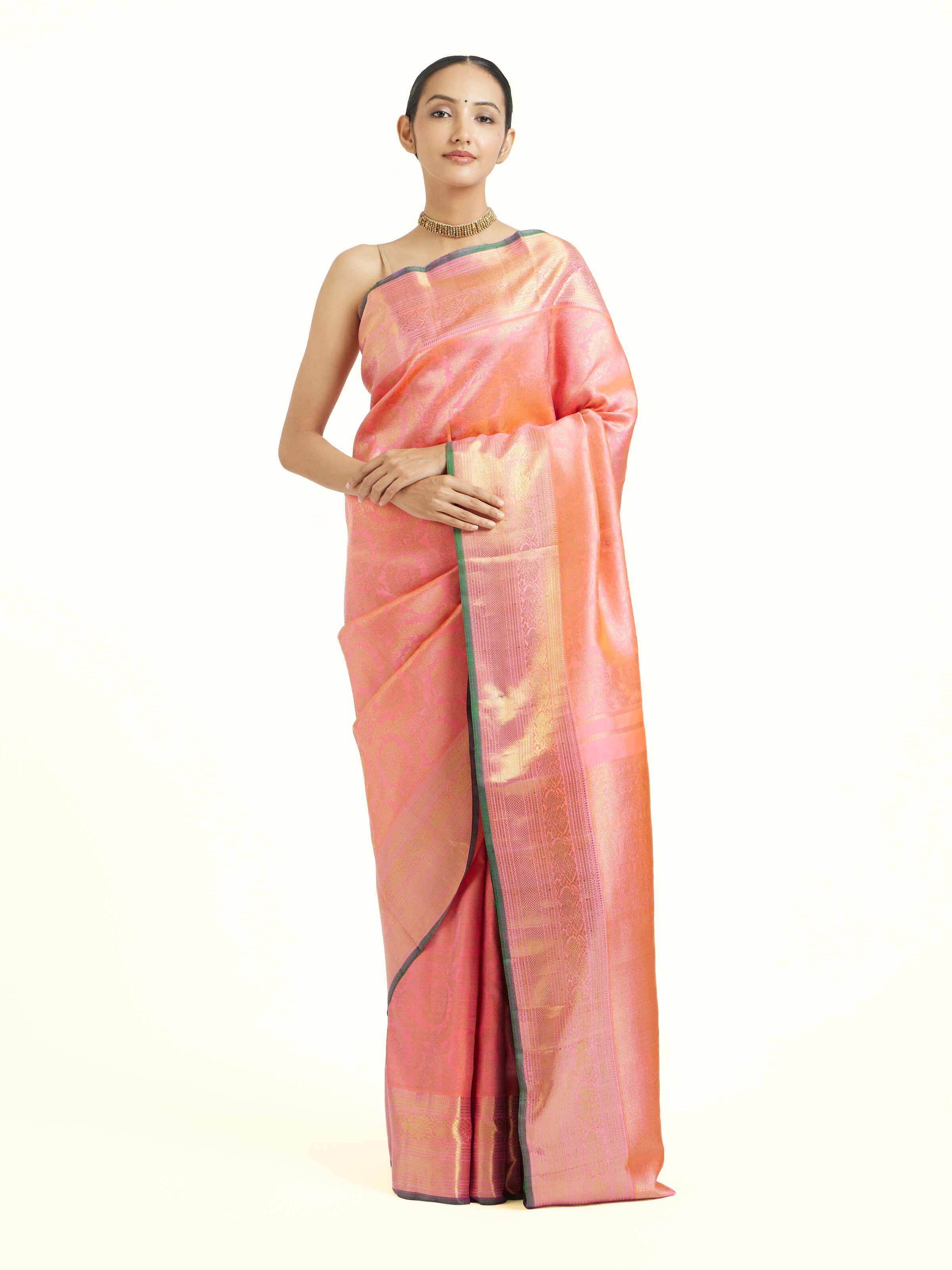Front view of pink silk Kancheepuram saree with rich zari woven motifs