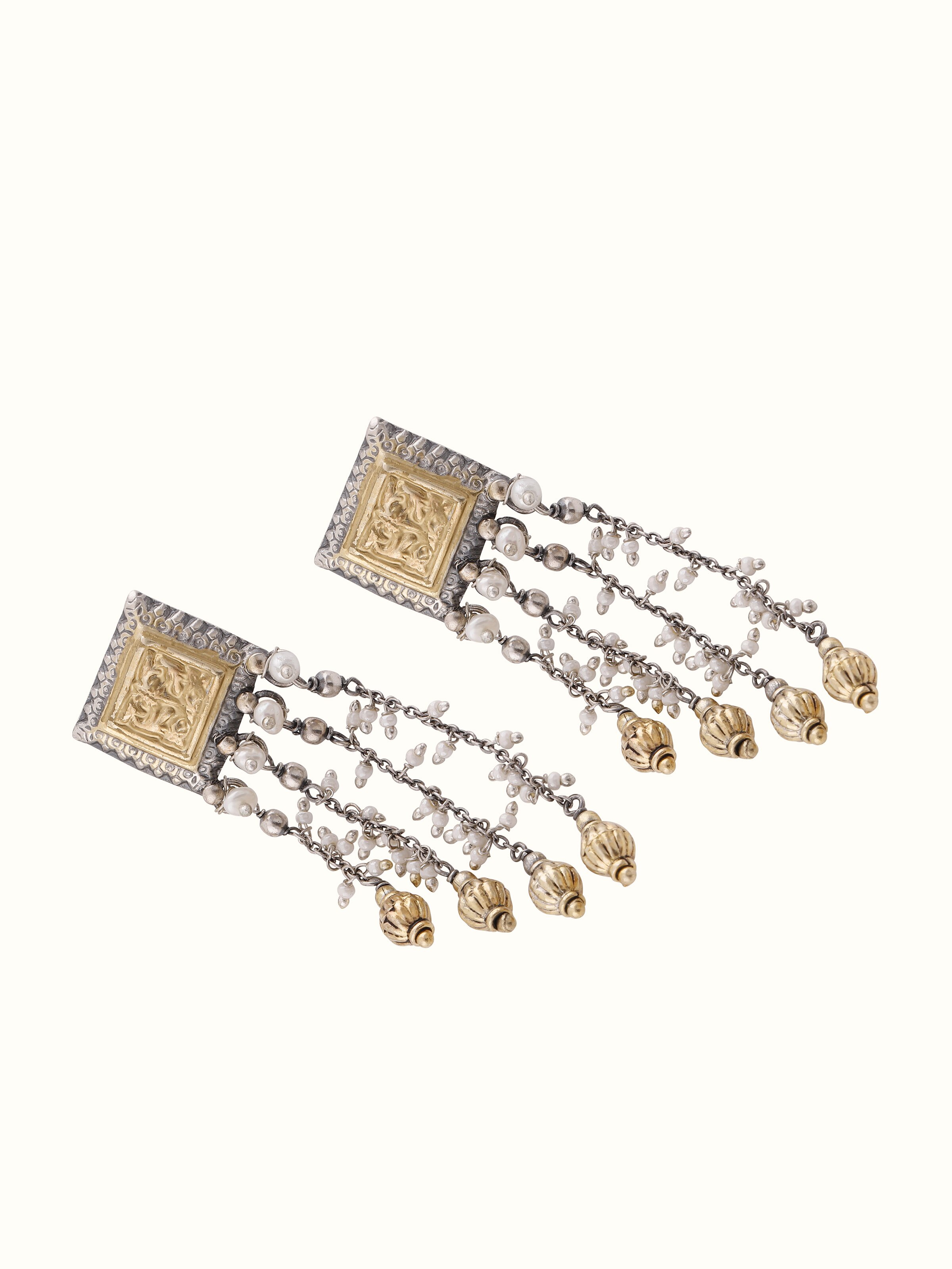 Worn view of silver smithing drop earrings