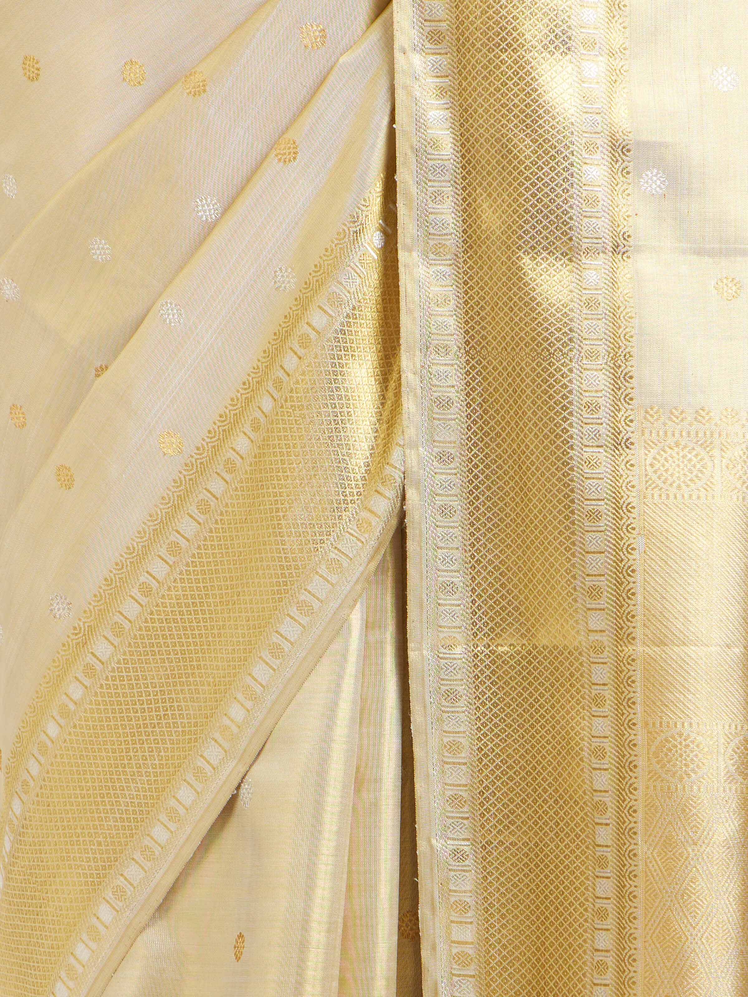 Detail view of beige silk Kancheepuram saree highlighting silk texture and zari work
