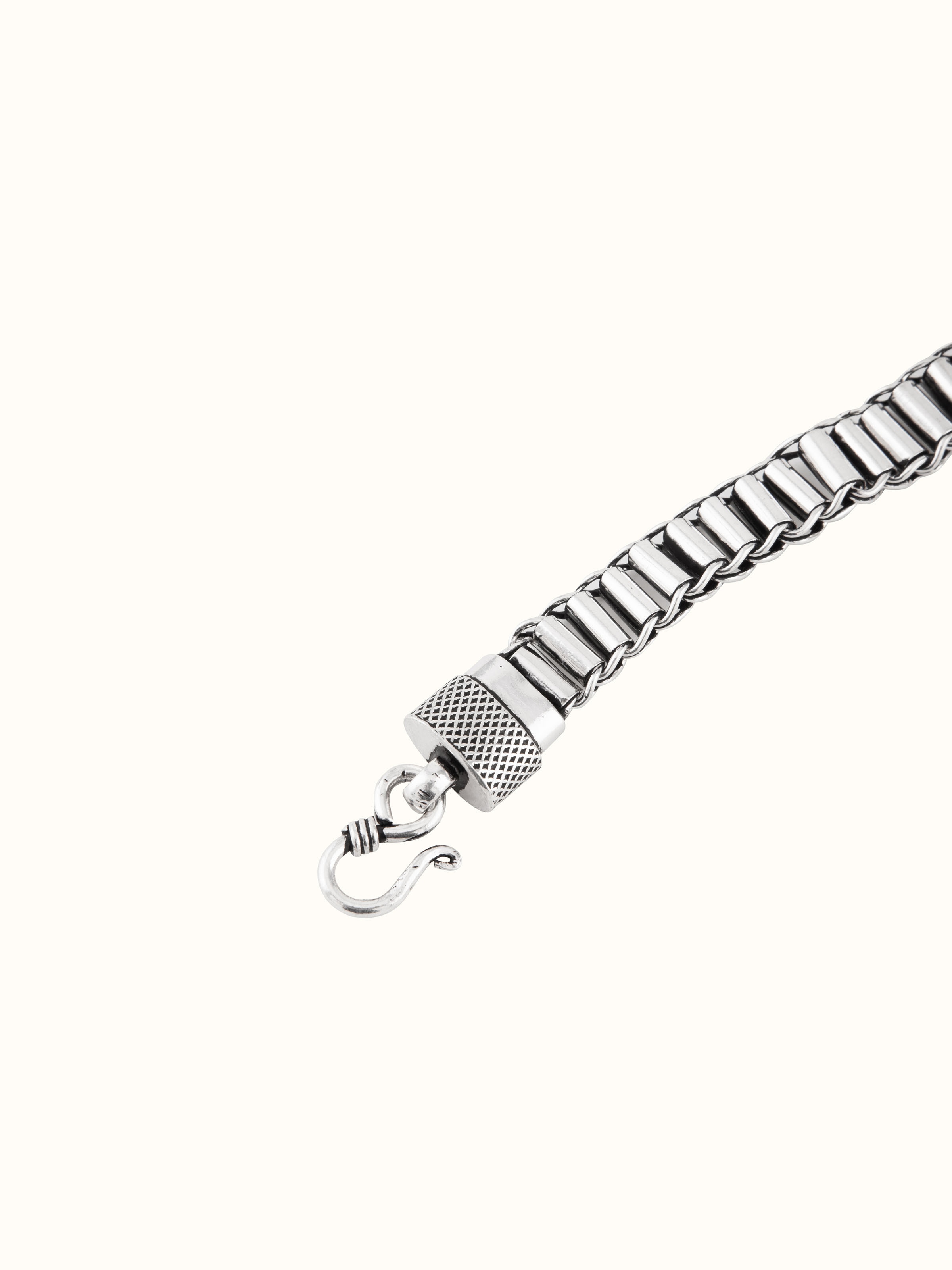 Overhead view of silver men’s bracelet arranged to showcase length and pattern