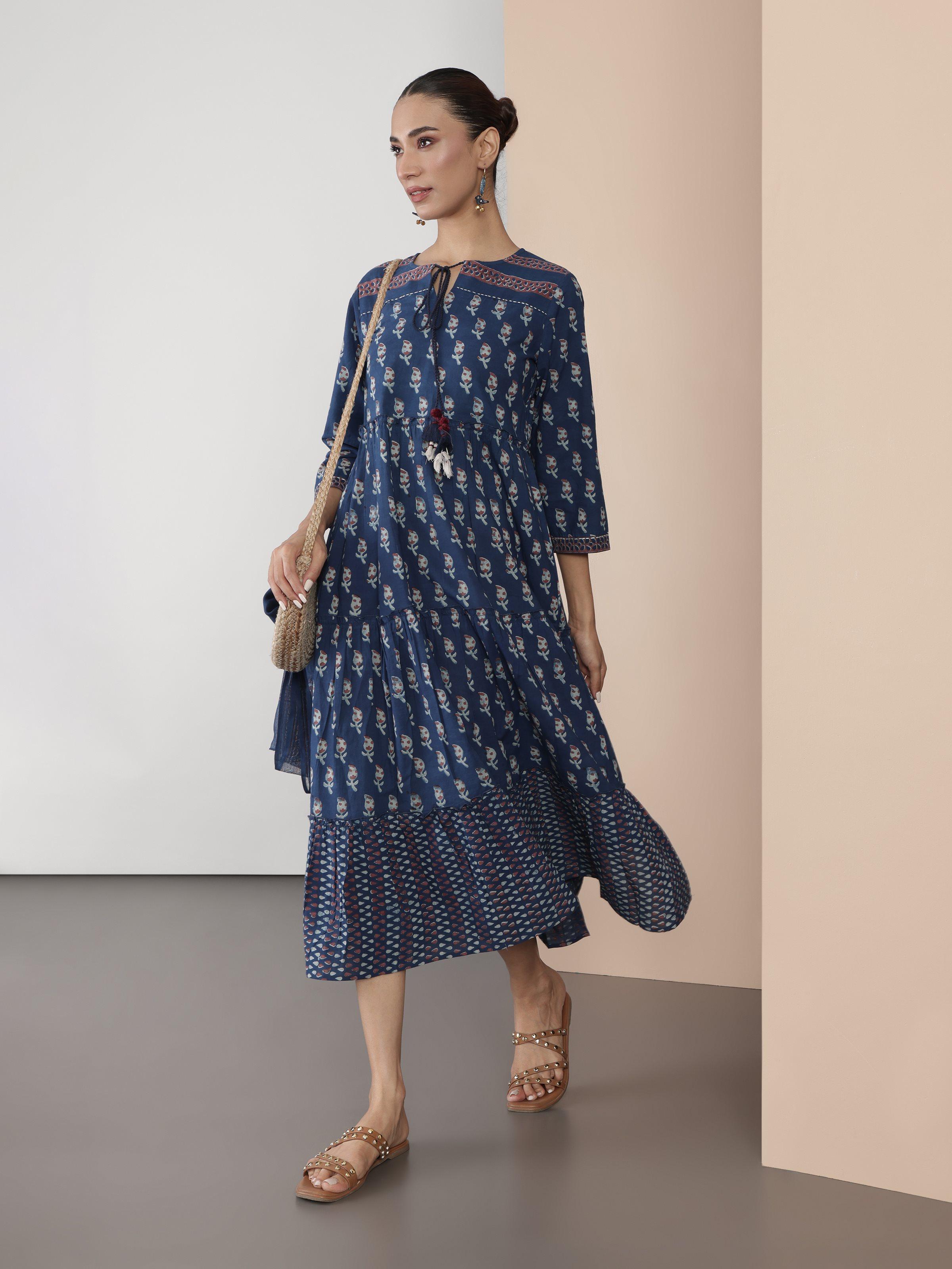 Alternate lifestyle view showing flare and print detail of blue cotton Dabu block printed midi dress