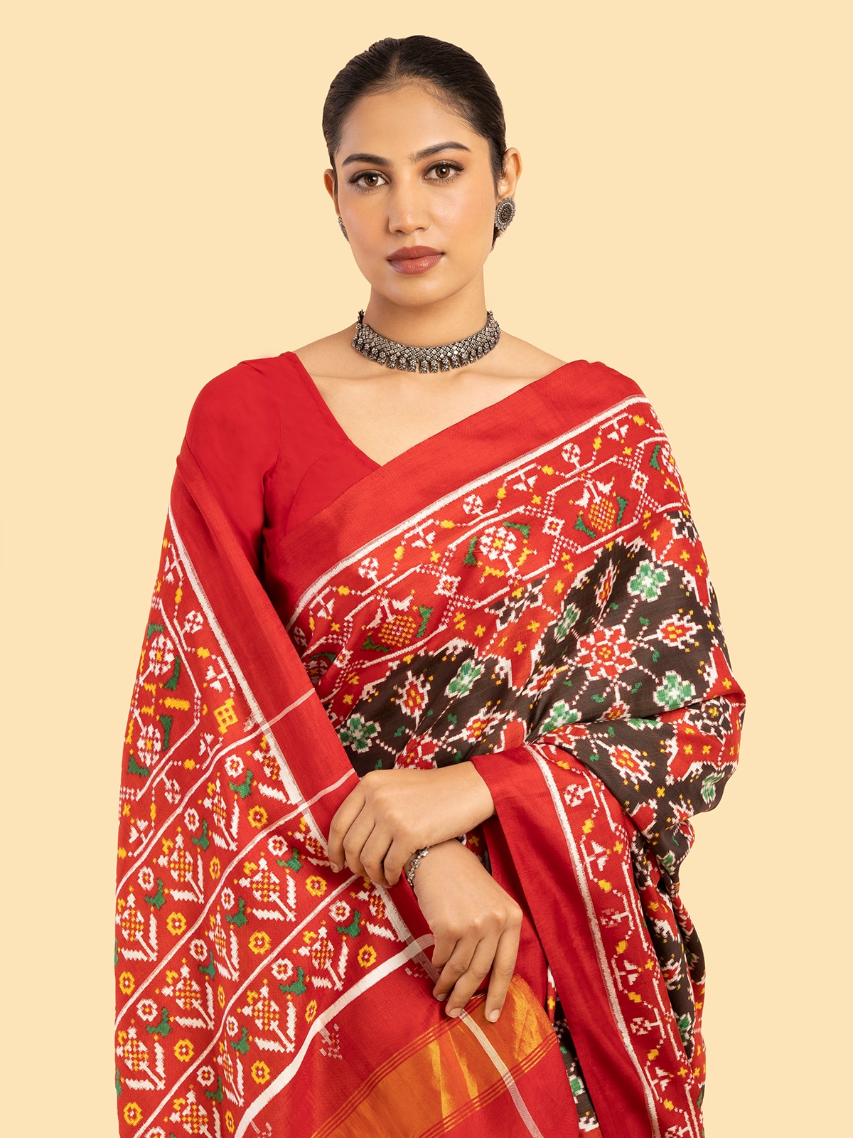 Close-up of brown silk patola saree highlighting intricate pattern and color richness
