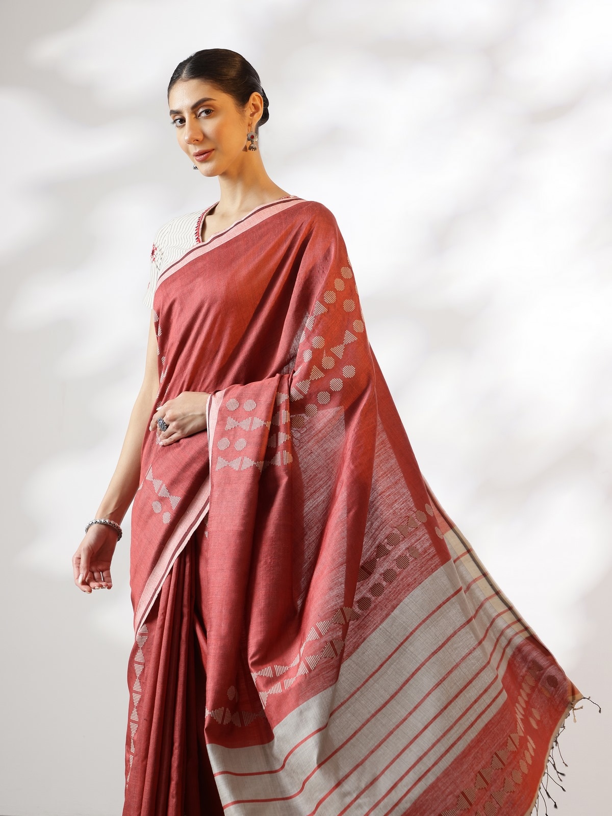 Angled view of Maroon Silk Extra-weft Saree highlighting rich silk sheen and detailed weave pattern.