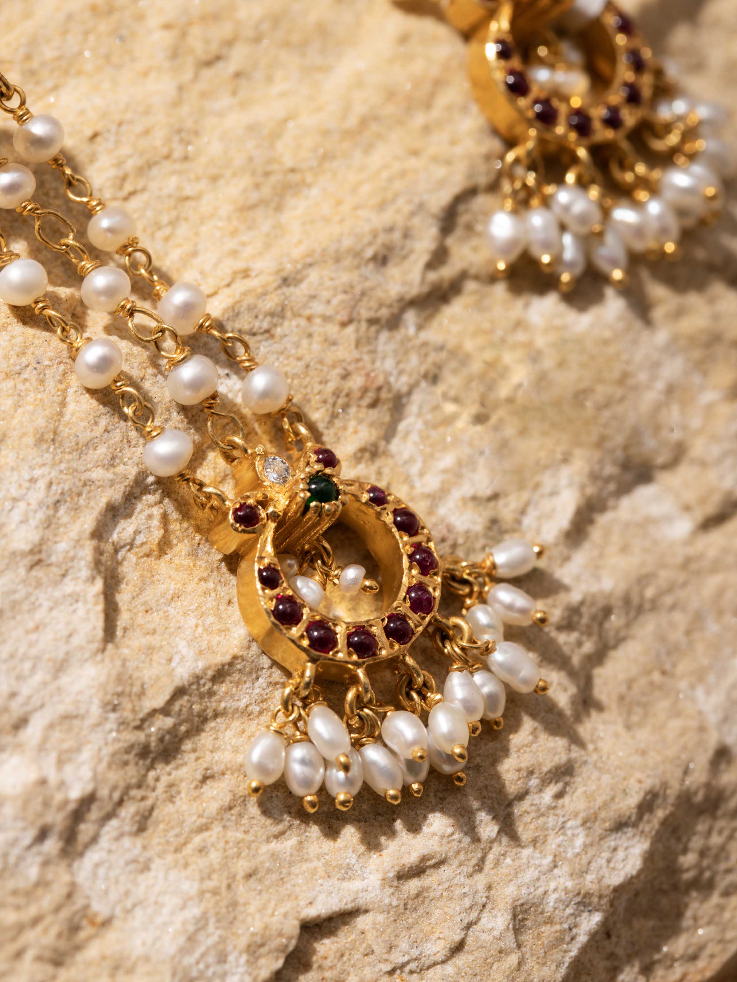 Detailed close-up revealing the earrings’ artisanal silver beads and classic drop structure