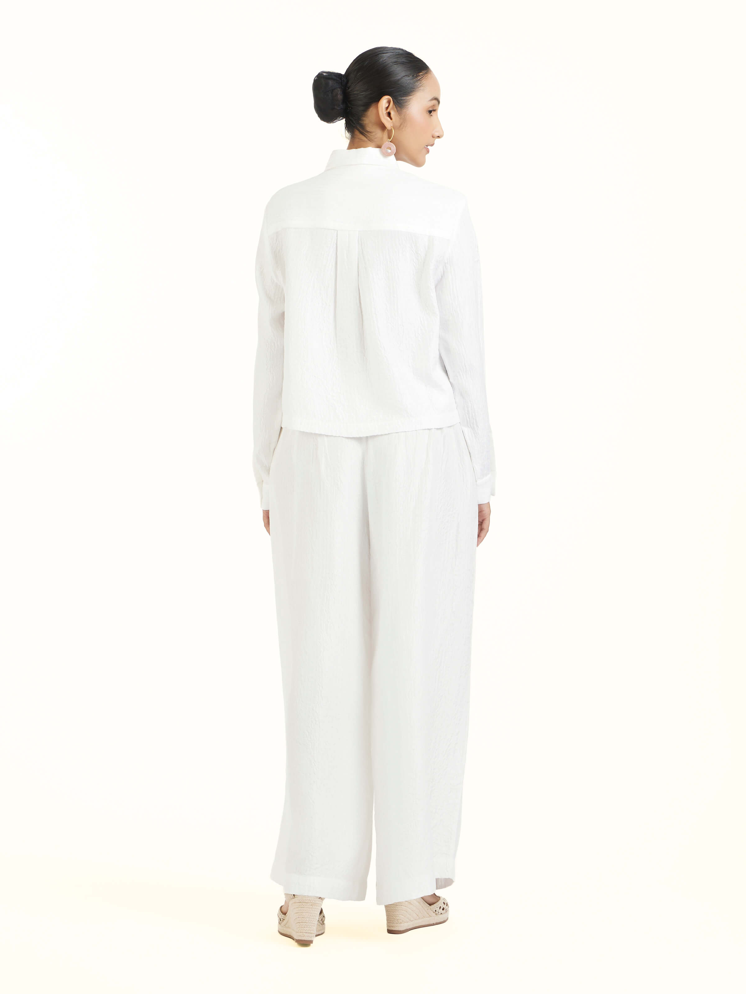 Back view of ivory quilted silk pants displaying clean finish