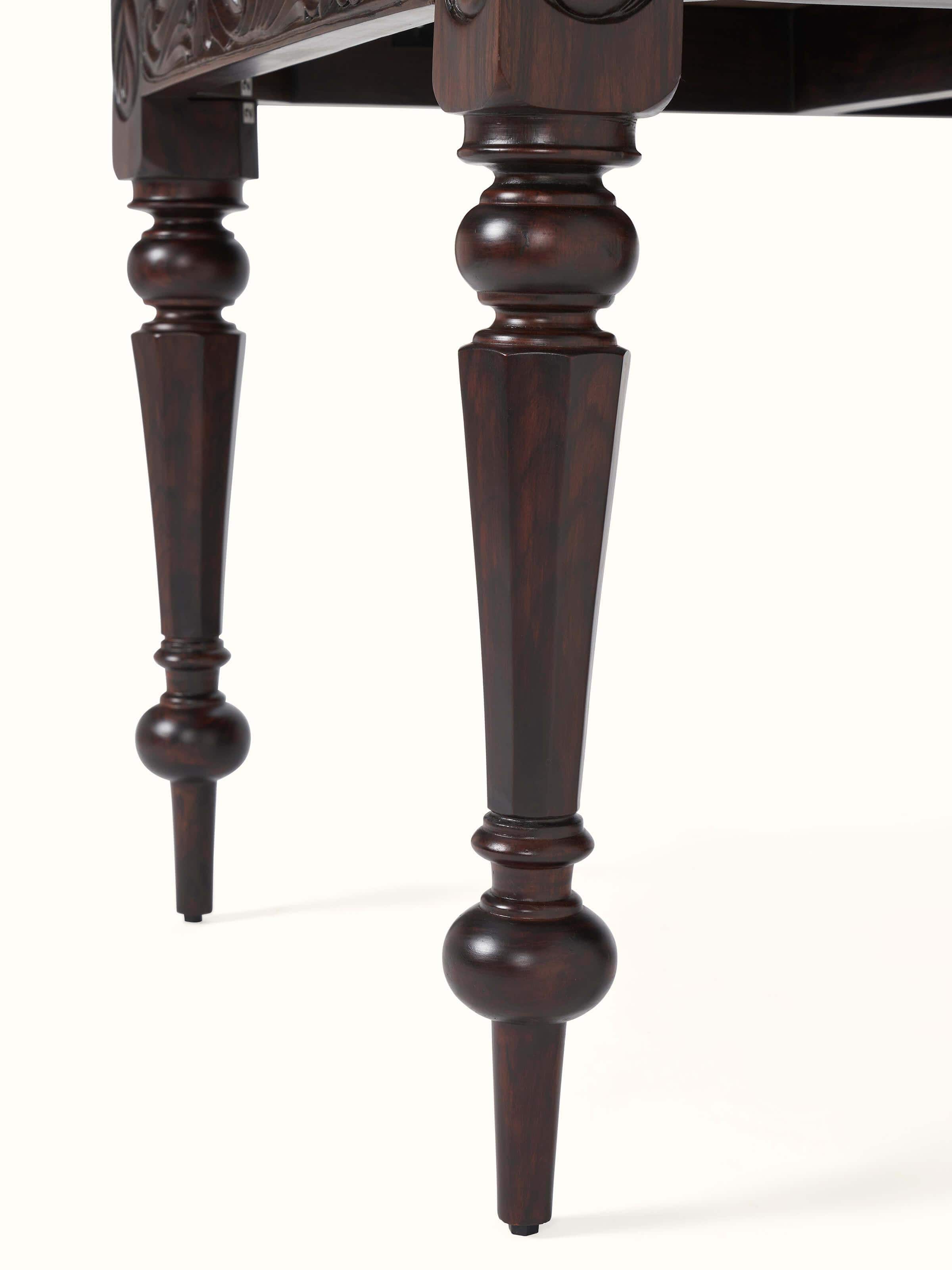 Detailed view of the carved rosewood 6-seater dining table legs, emphasizing the intricate carving and sturdy construction