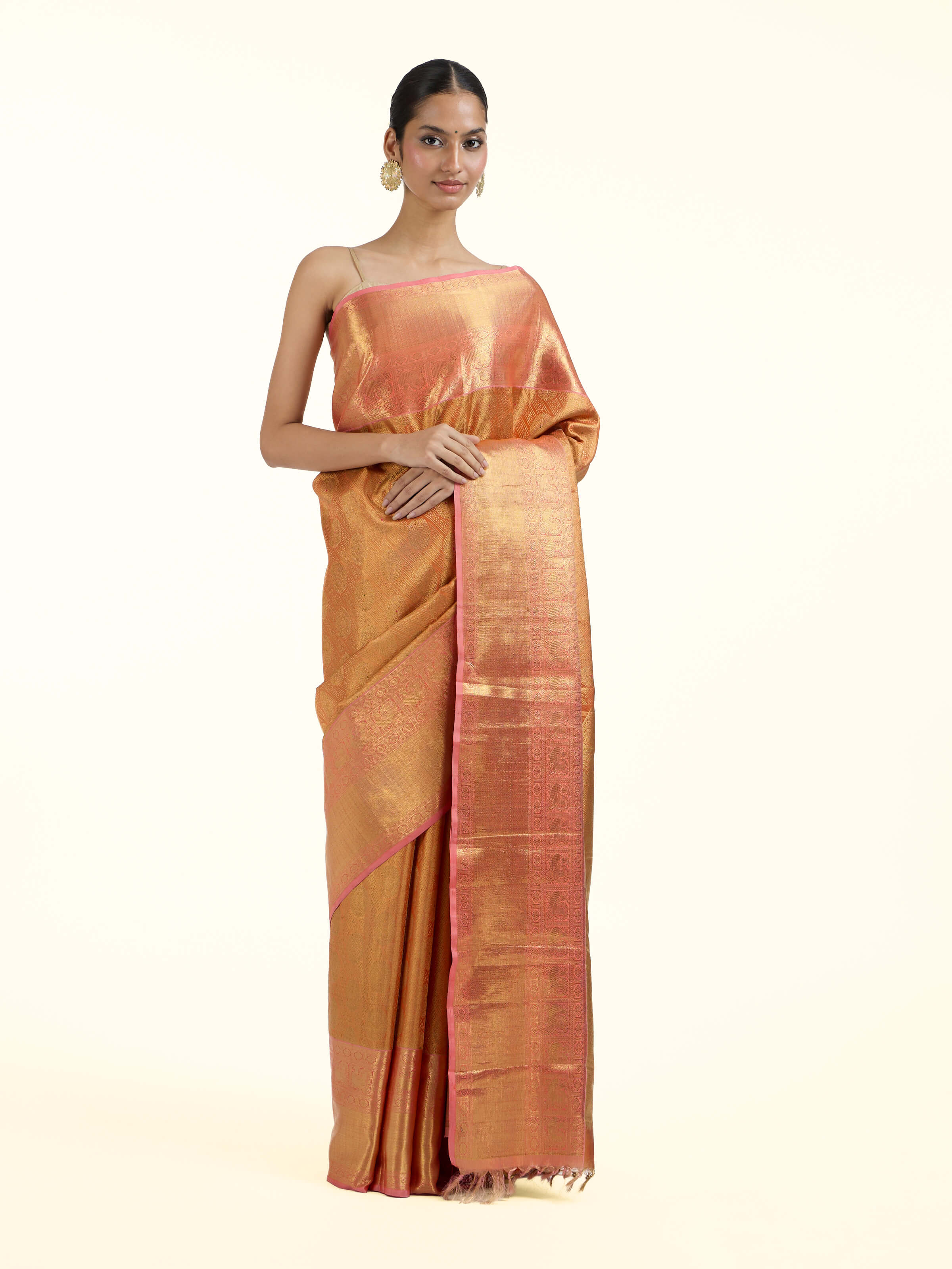 Front view of yellow silk Kancheepuram saree with rich zari woven motifs