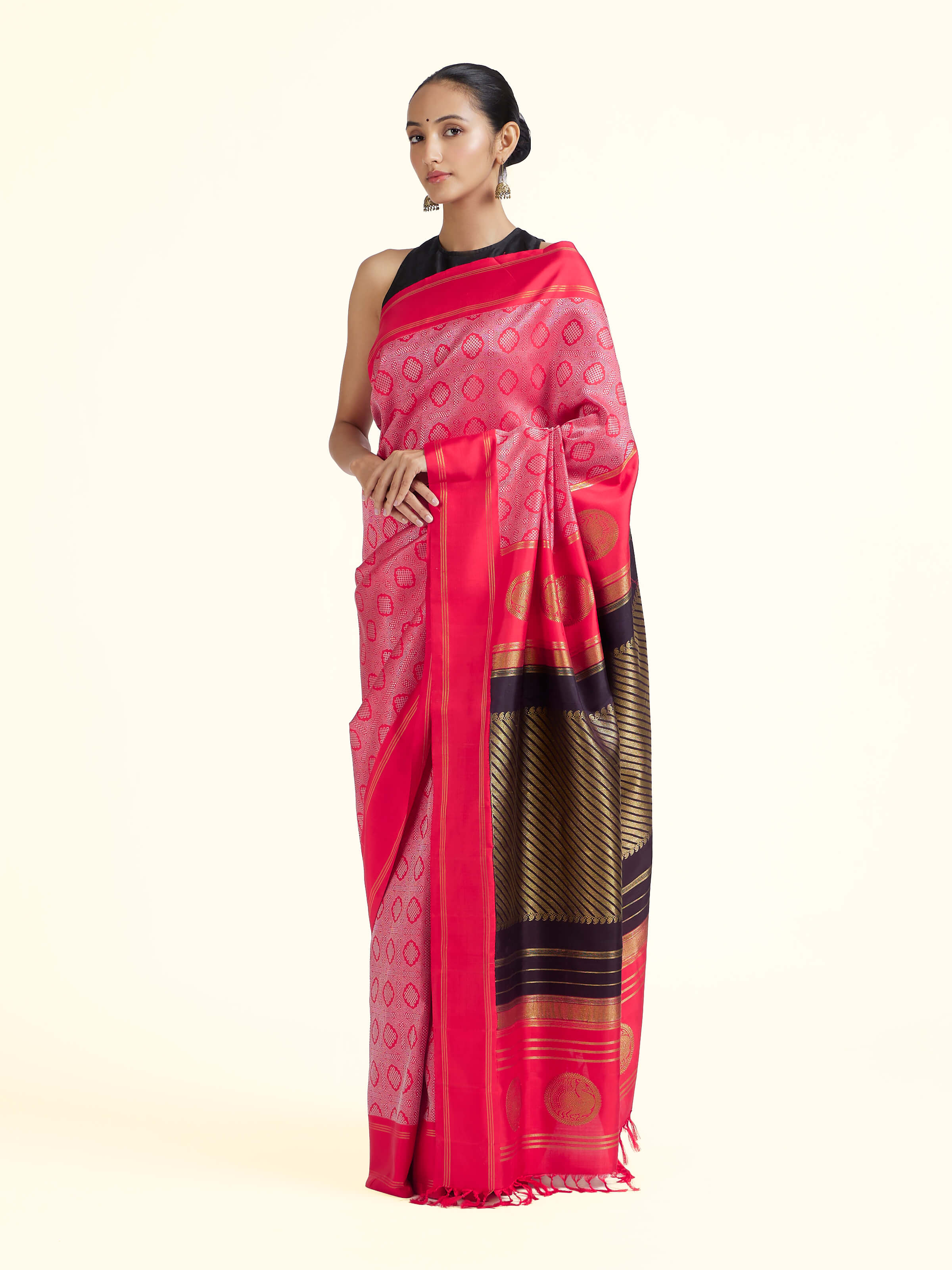 Side view of red silk Kancheepuram saree with graceful drape and contrast border