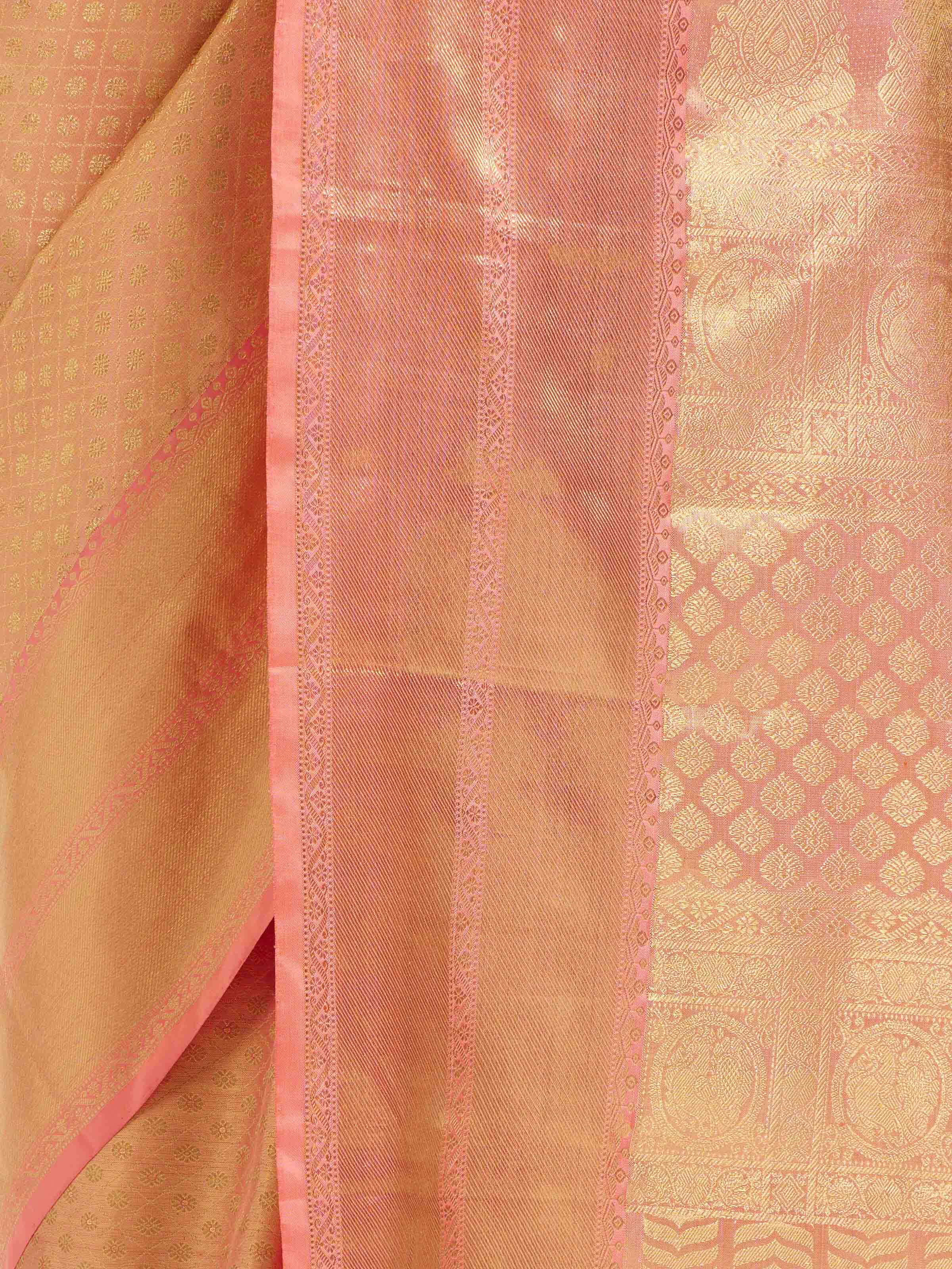 Detail view of peach silk Kancheepuram saree showing zari work