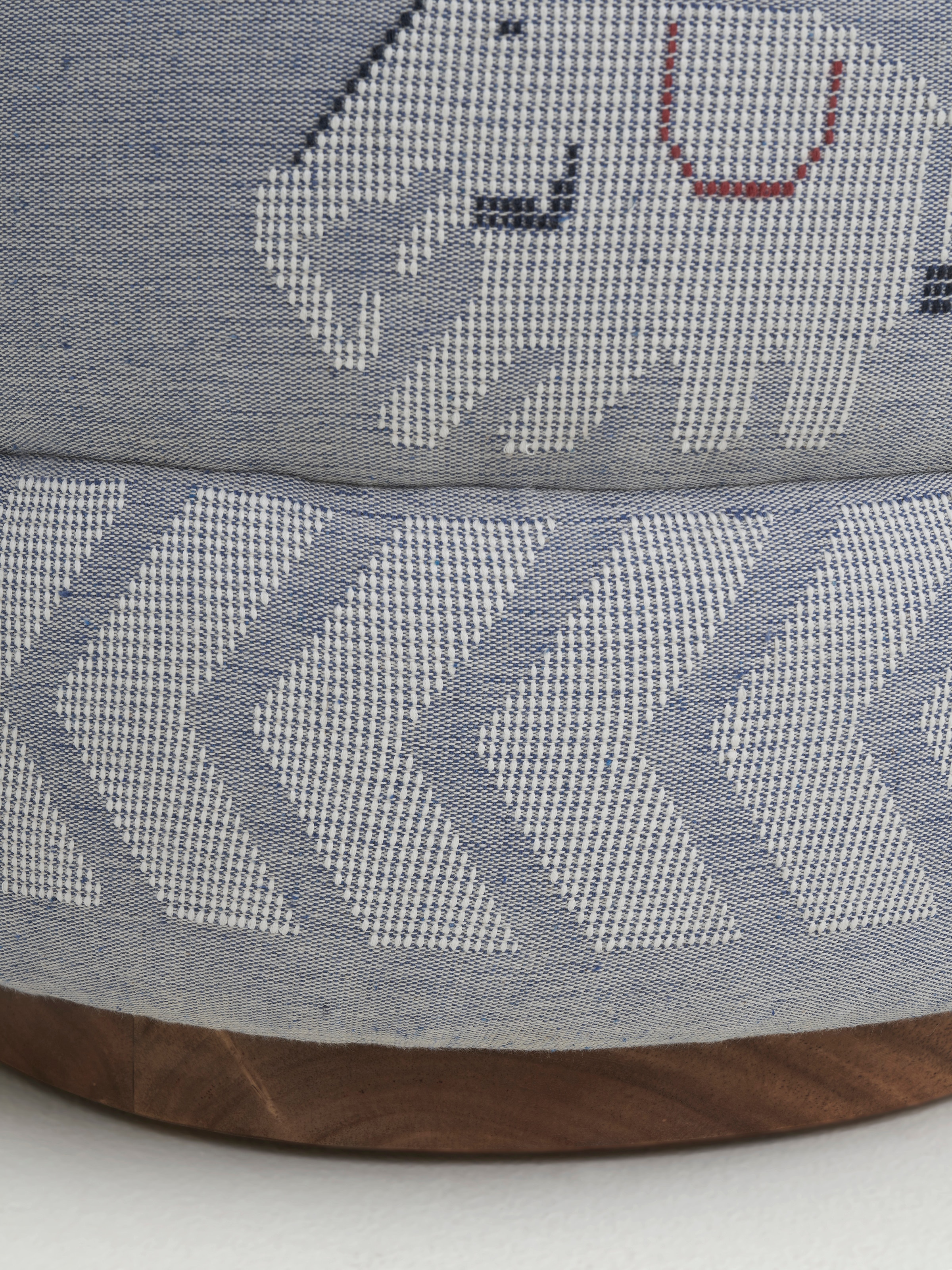 Angled view of the pouffe, capturing the overall design and the craftsmanship of the Sheesham wood base