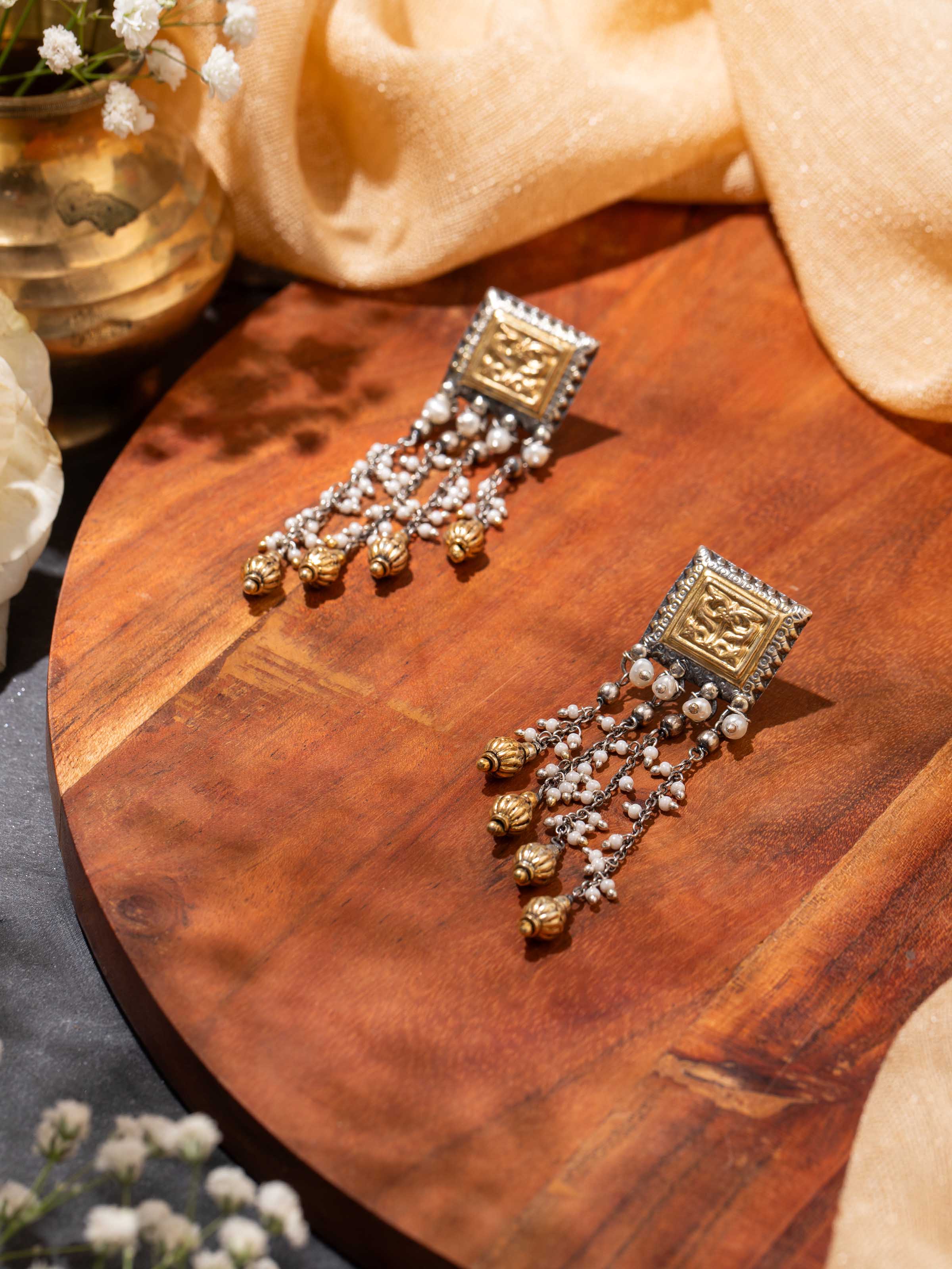 Lifestyle view of silver smithing drop earrings