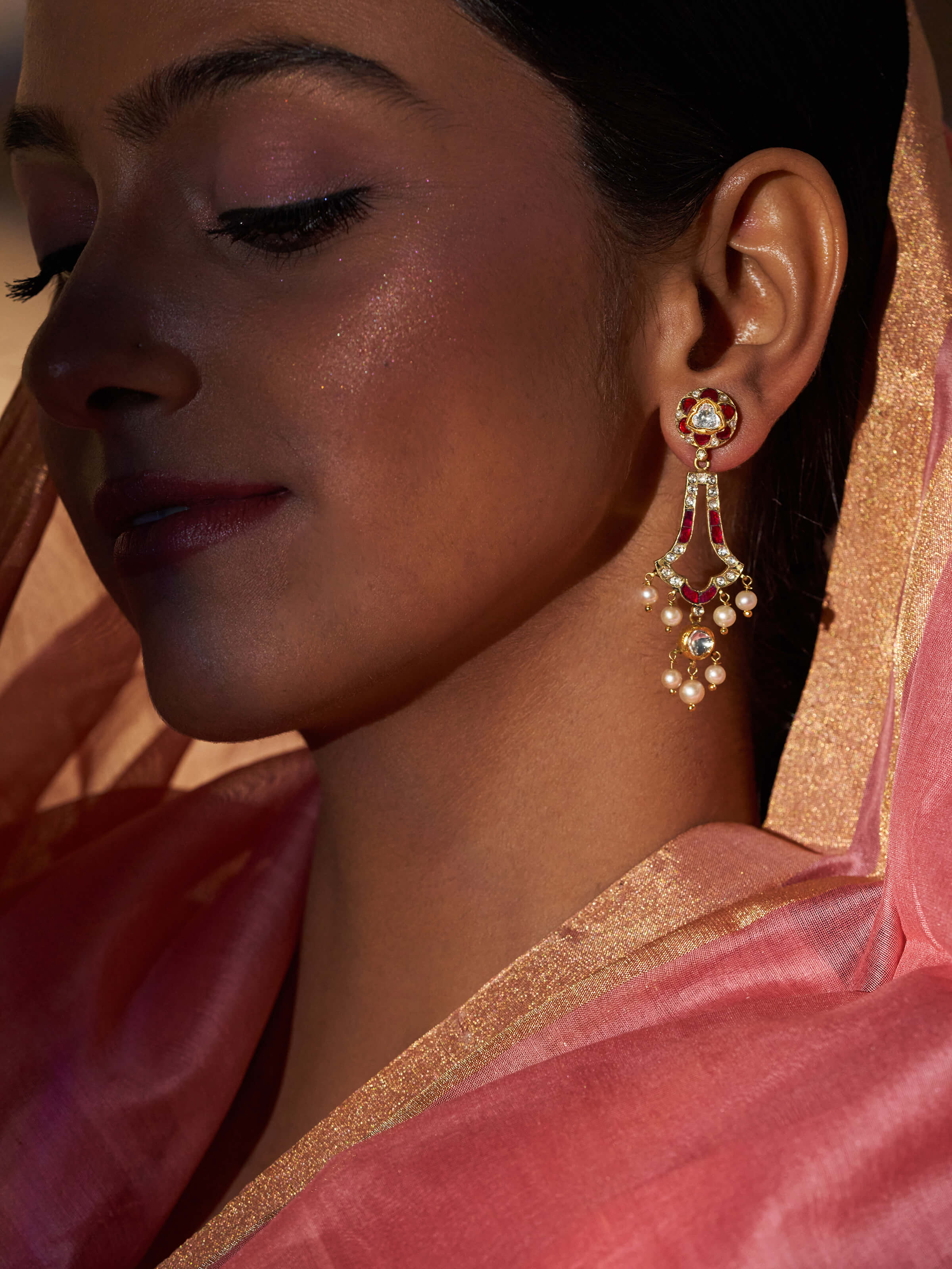 Close-up view of Partash 18 Karat Gold Drop Earrings showing intricate gold work and shine.