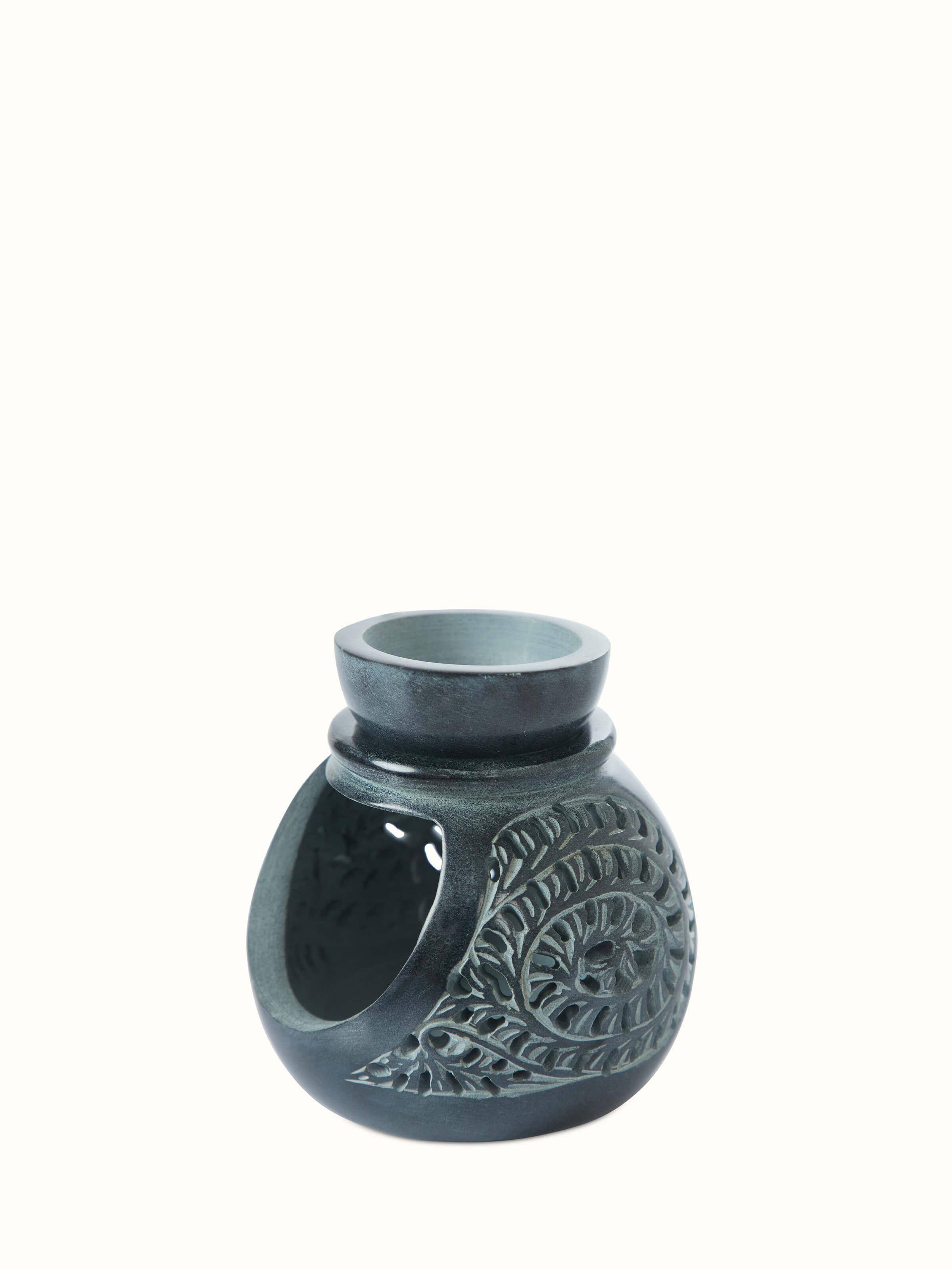 Close-up view of Carved soapstone aroma oil burner showcasing the fine details of its carvings and craftsmanship