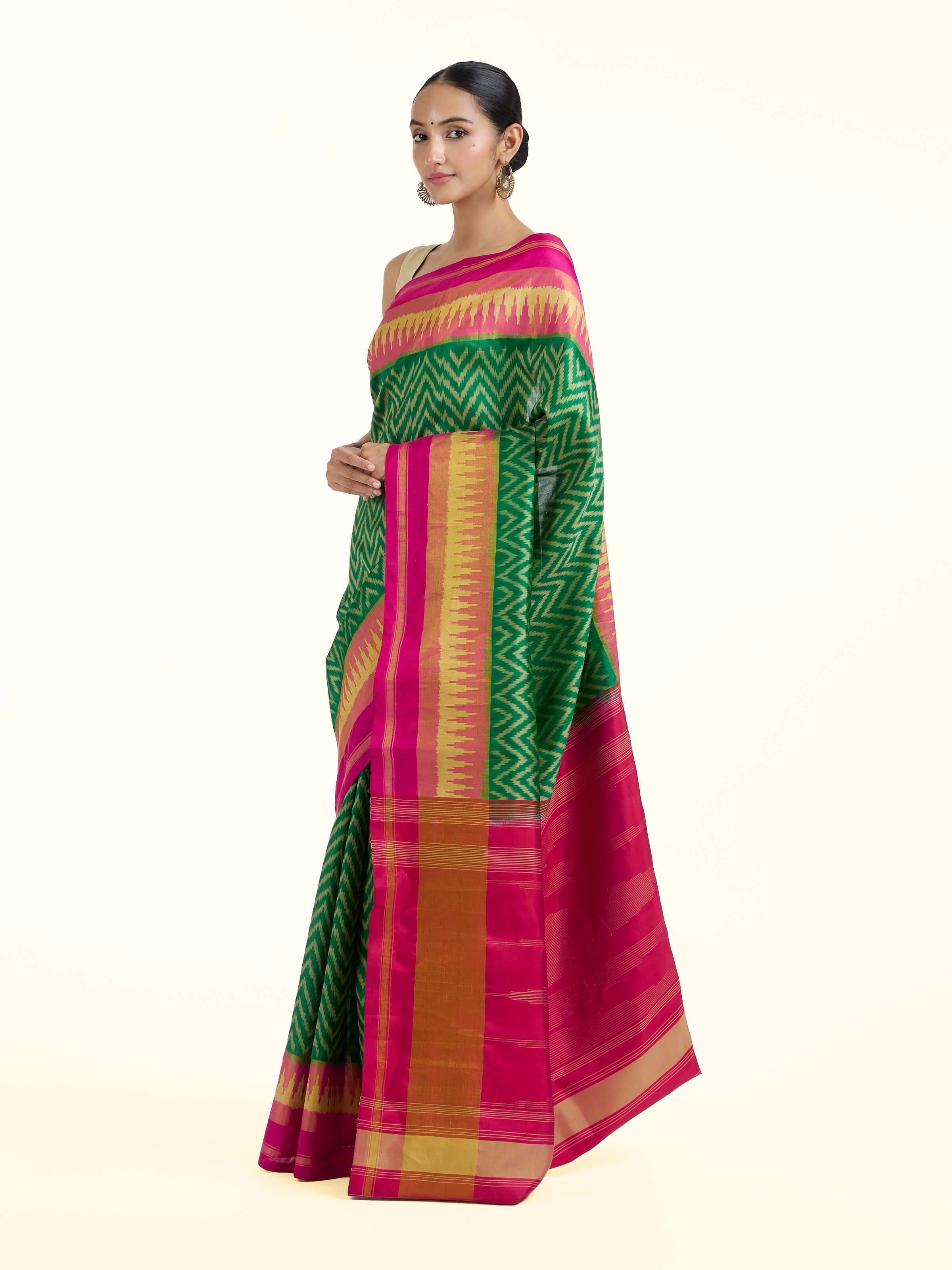Side view of green mulberry silk patola saree with elegant drape and patterned border