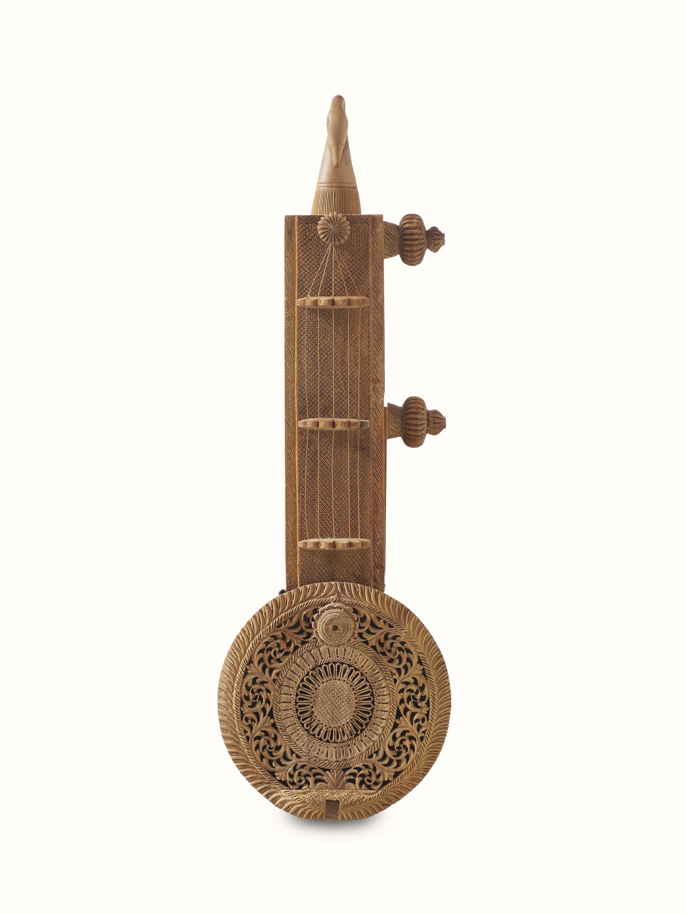 Front view of carved sandalwood devotion veena sculpture, showcasing intricate carvings and fine details.
