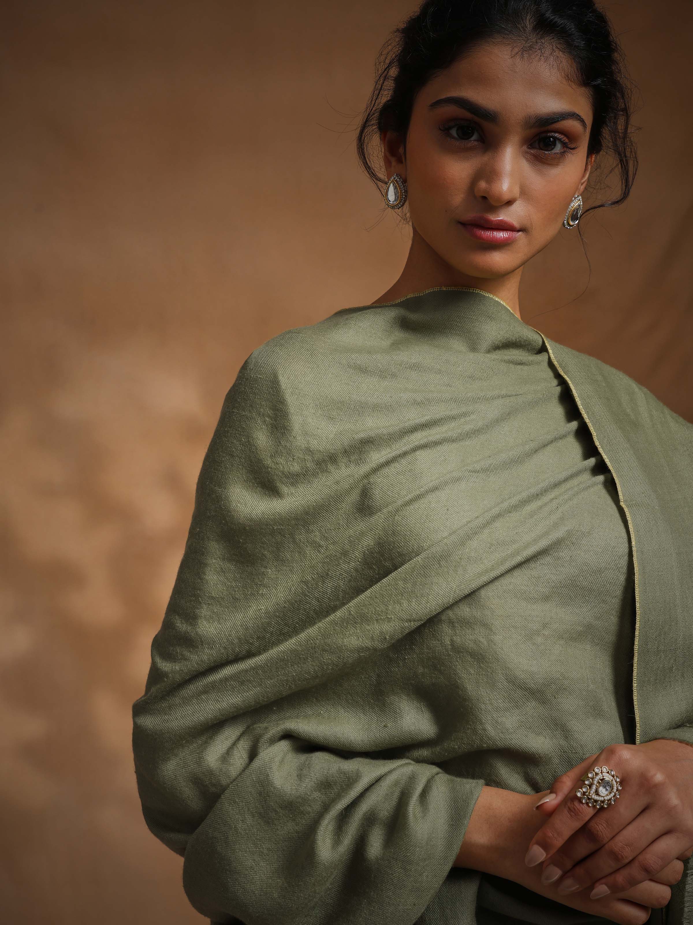 Close-up angled view of green cashmere Kaaj embroidered handwoven stole showcasing embroidery precision