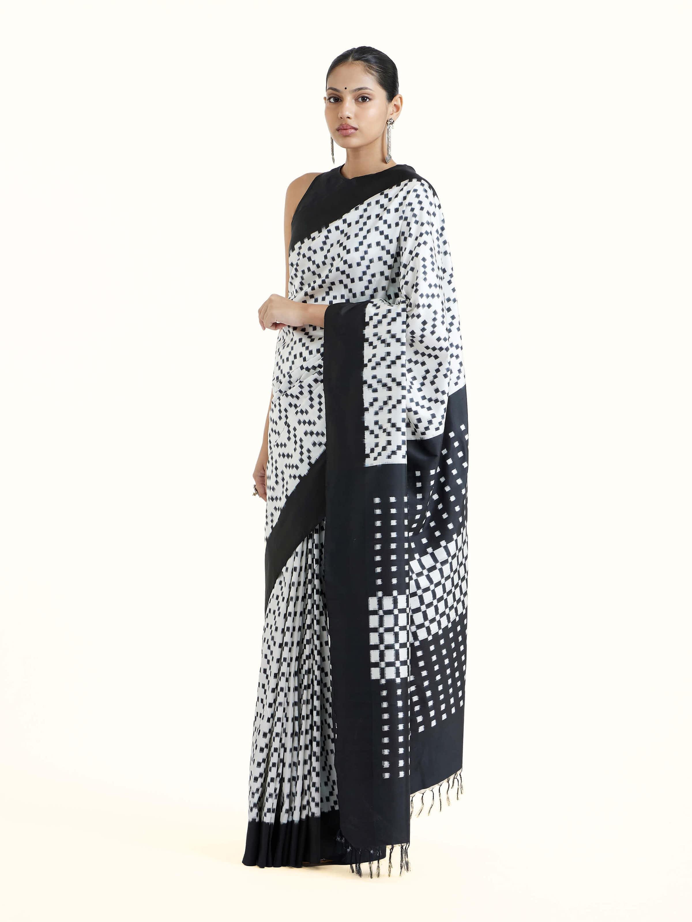 Side view of black silk double ikat saree with elegant drape and border detail